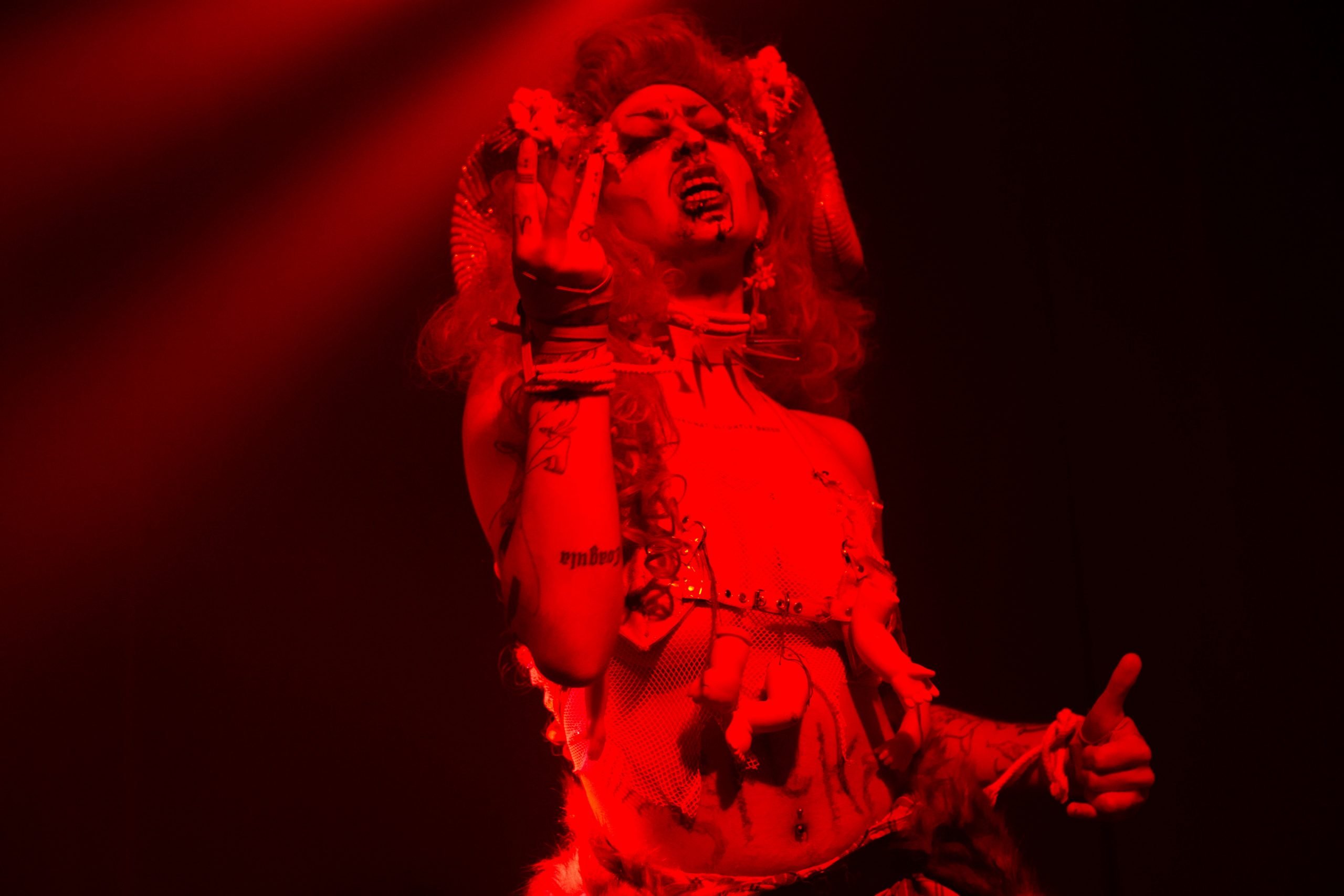 A performer bathed in red light.