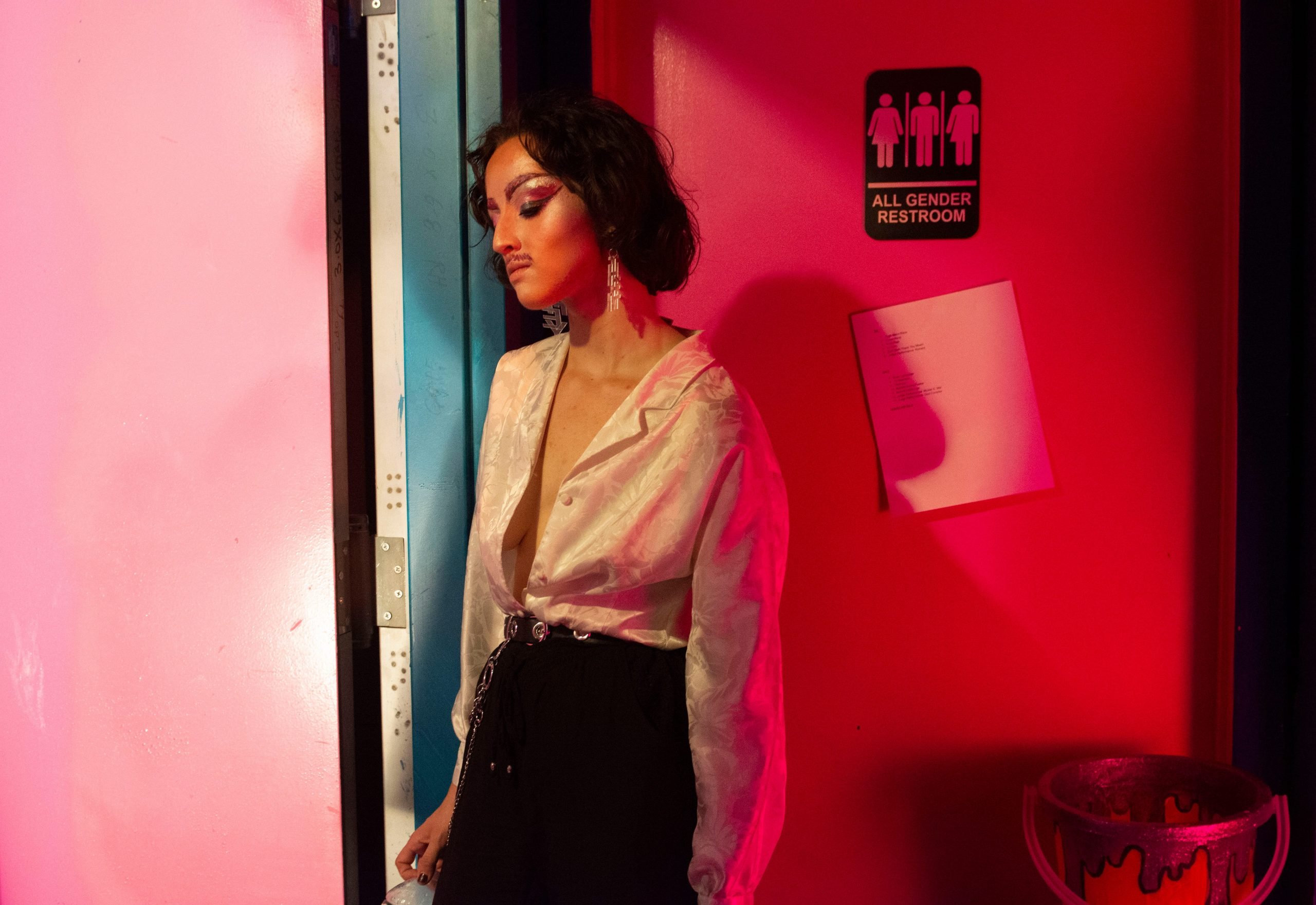 A contestant backstage by a bathroom door.