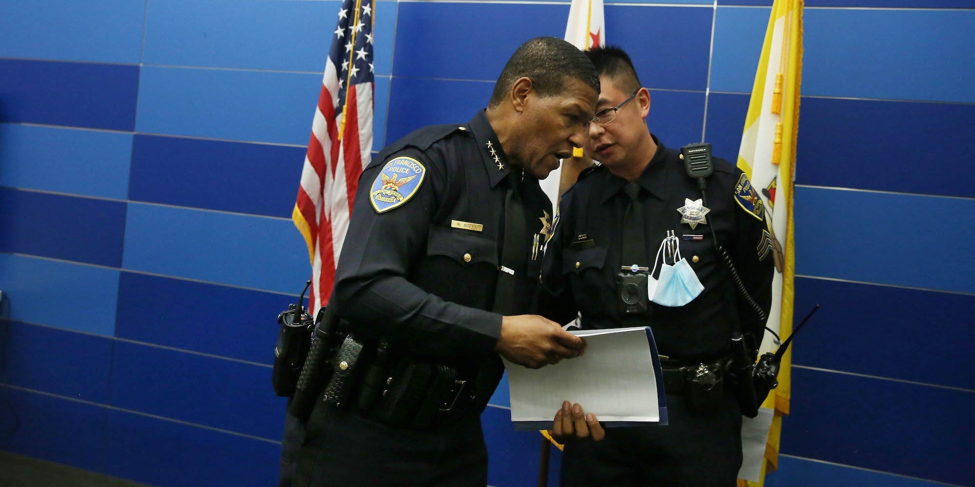 San Francisco Police Chief Bill Scott (l to r) speaks to Sergeant Kin Lee at the end of a press conference on mid-year report on public safety statistics on Monday, July 12, 2021 in San Francisco, California.