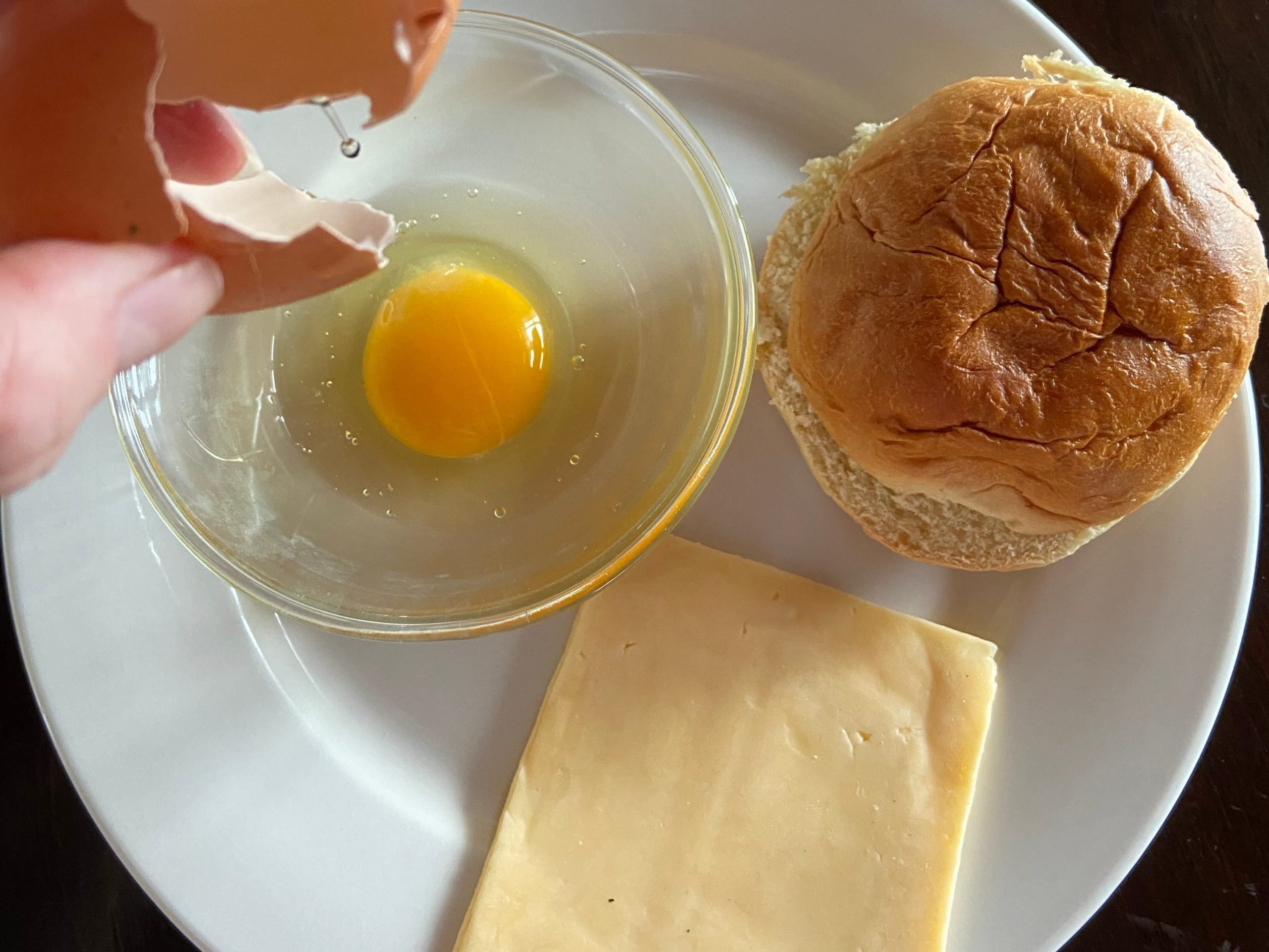 An egg, bread, and a slice of cheese.