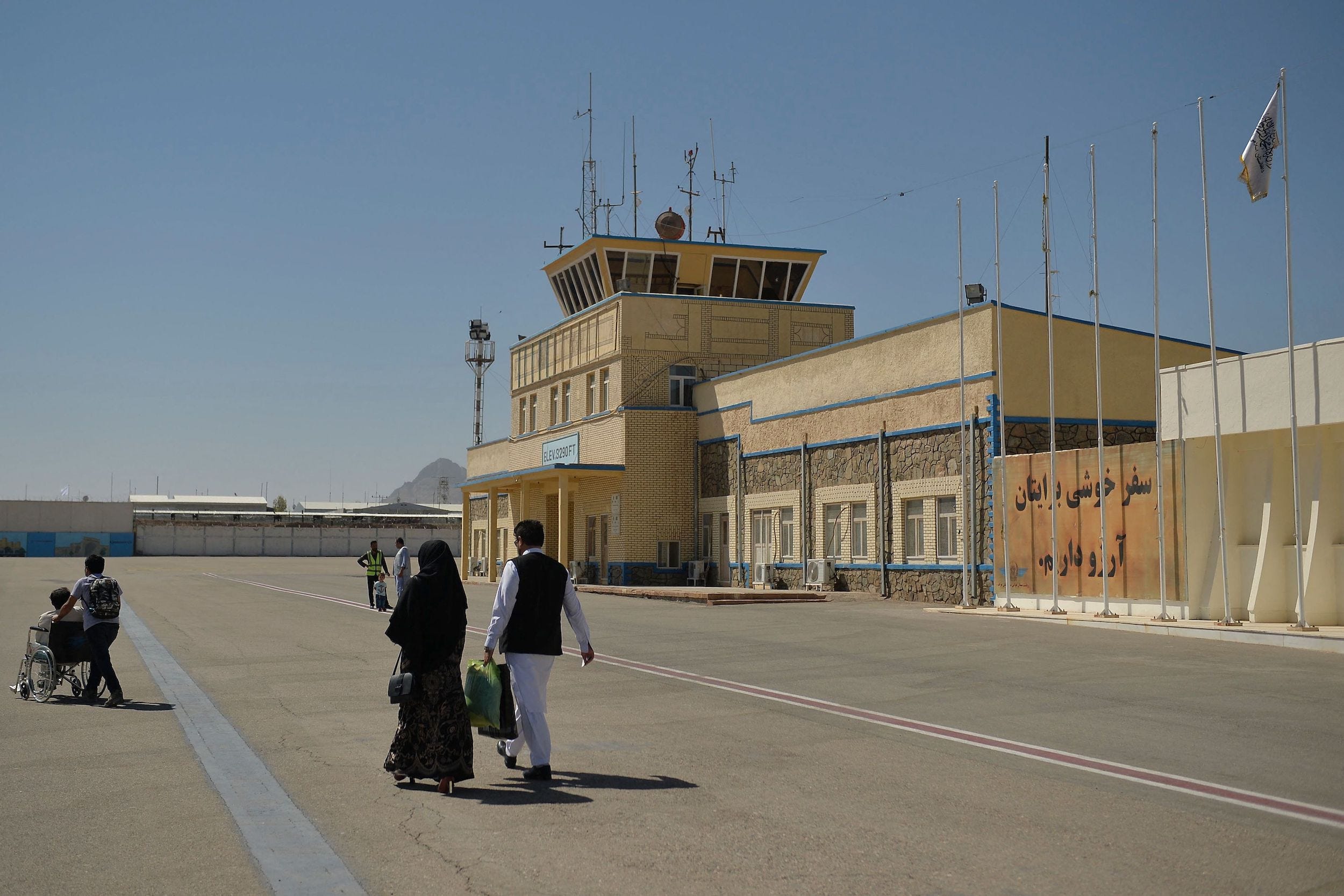 passengers on tarmac at kabul airport in afghanistan