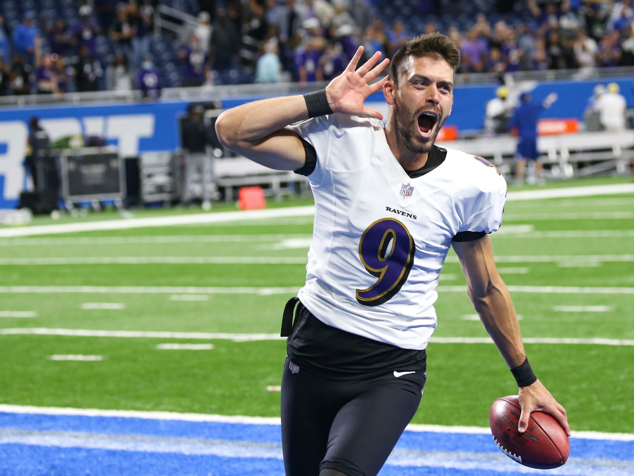 Justin Tucker celebrates after breaking NFL record with a 66-yard field goal to defeat the Detroit Lions.