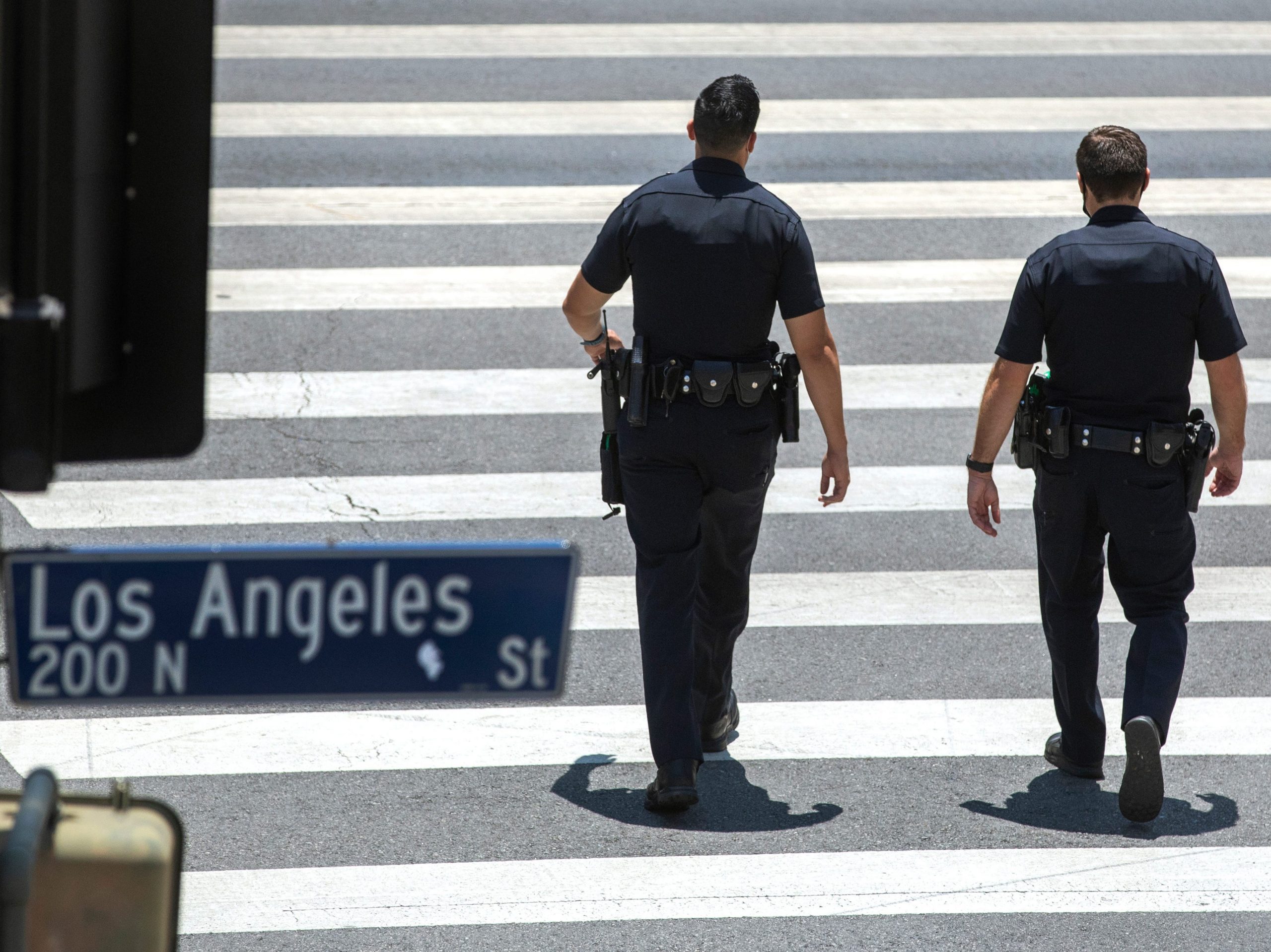 Members of the LAPD make their way along Temple St. in downtown Los Angeles.