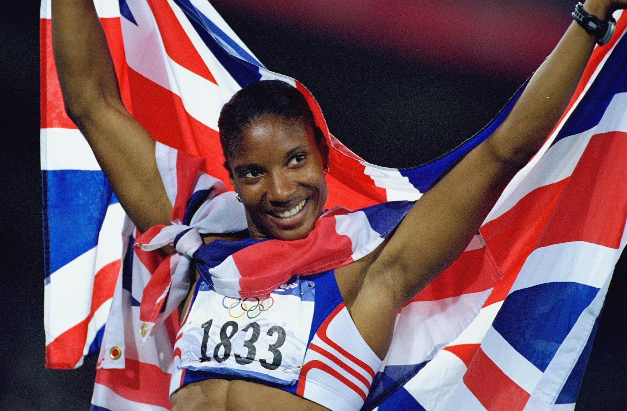 Denise Lewis of Great Britain celebrates with the Union Jack after winning Gold in the Womens Heptathlon at the Olympic Stadium on Day Nine of the Sydney 2000 Olympic Games in Sydney, Australia.
