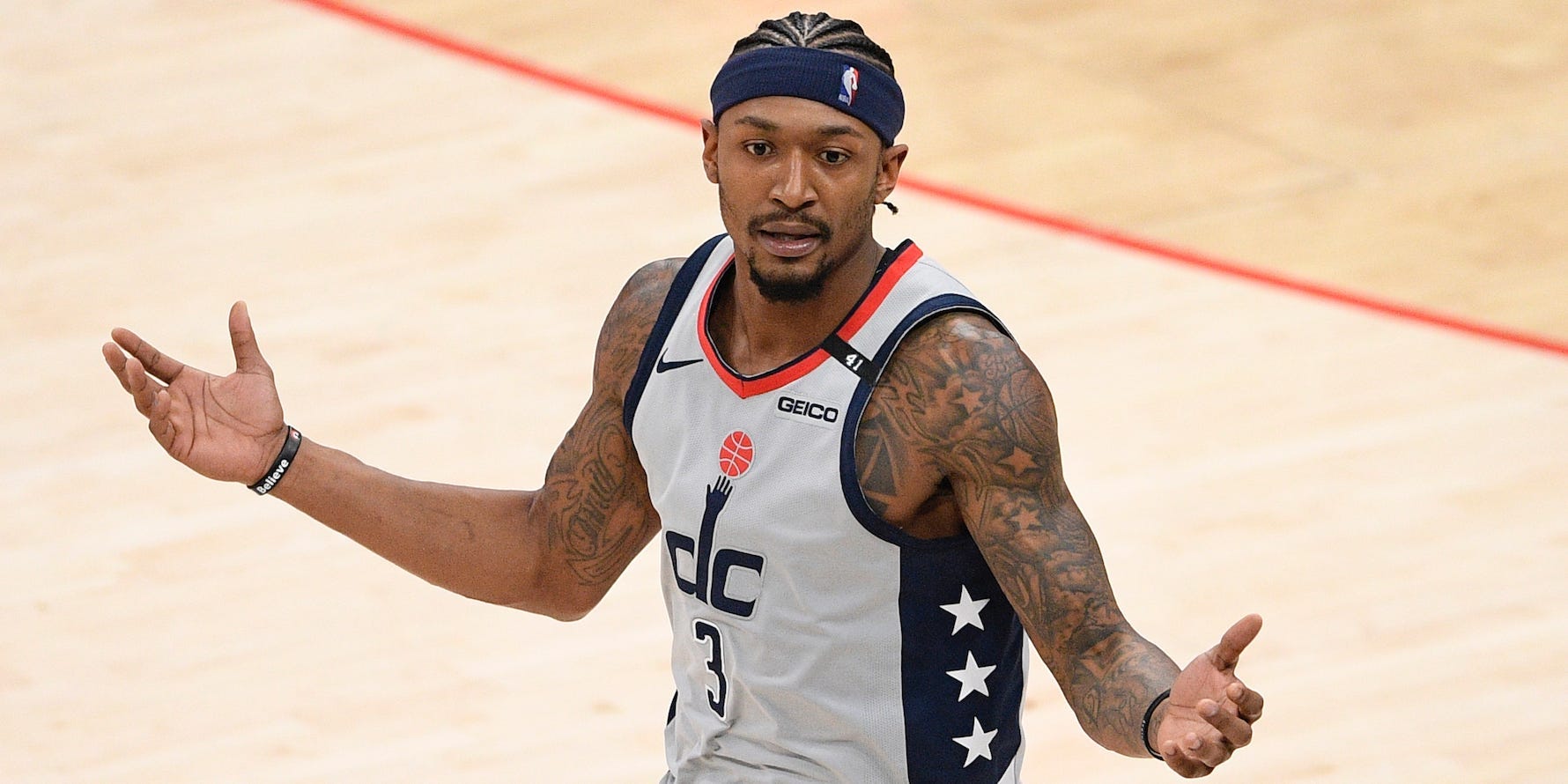 Bradley Beal holds his hands up during a game.
