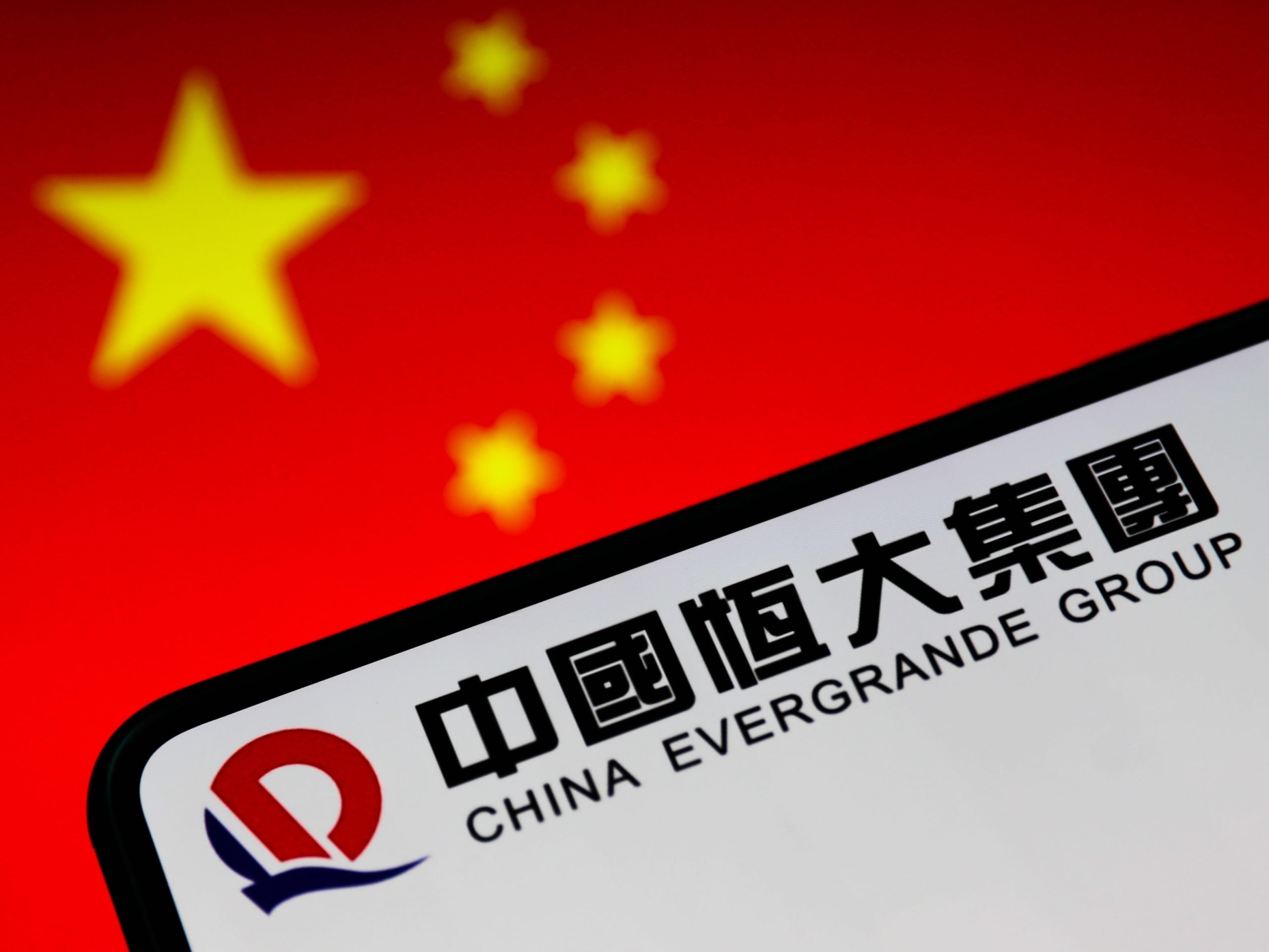 china evergrande group logo phone screen against background of chinese flag