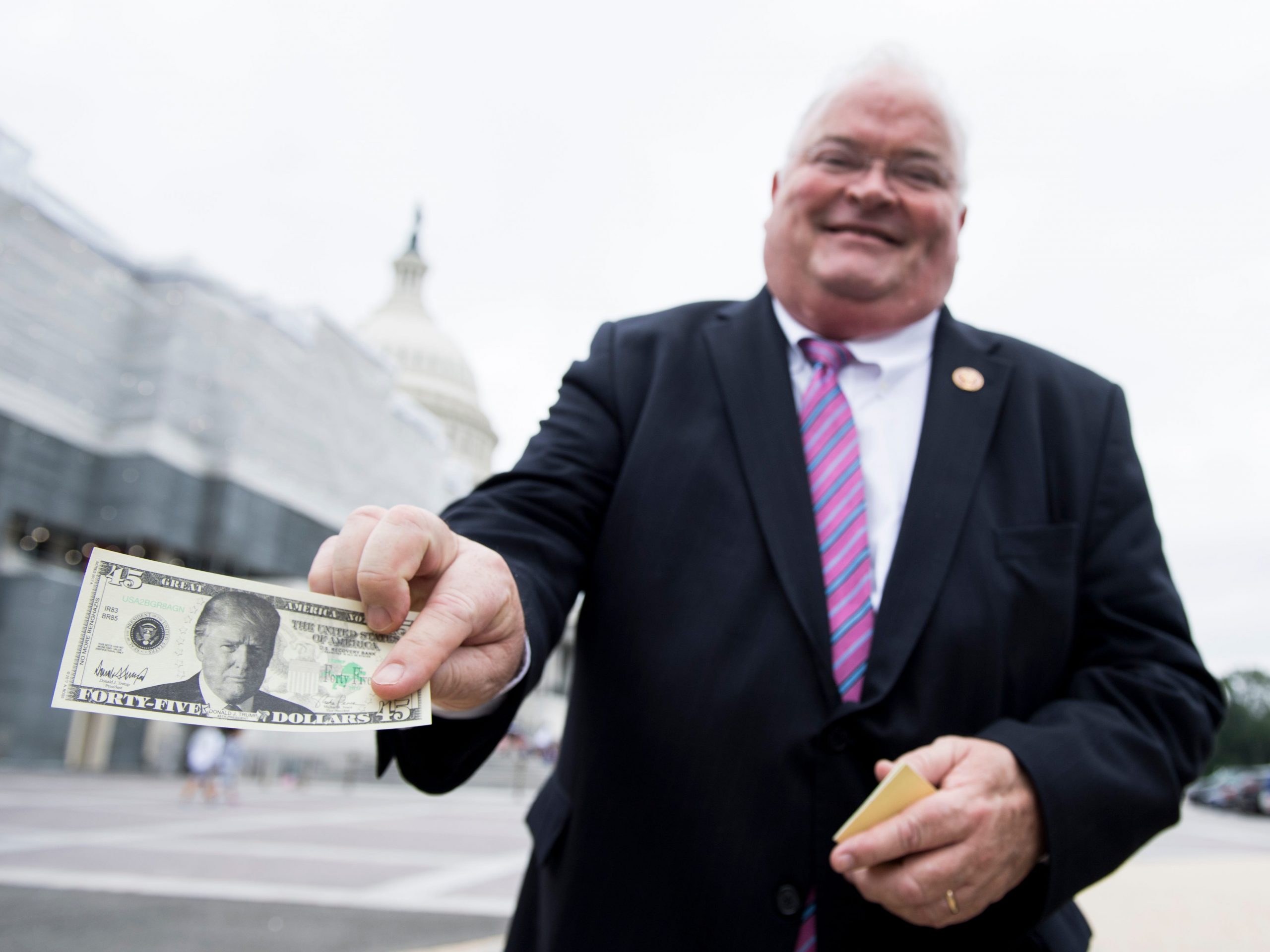 Republican Rep. Billy Long of Missouri shows off a $45 Trump bill outside of the US Capitol on May 9, 2019.