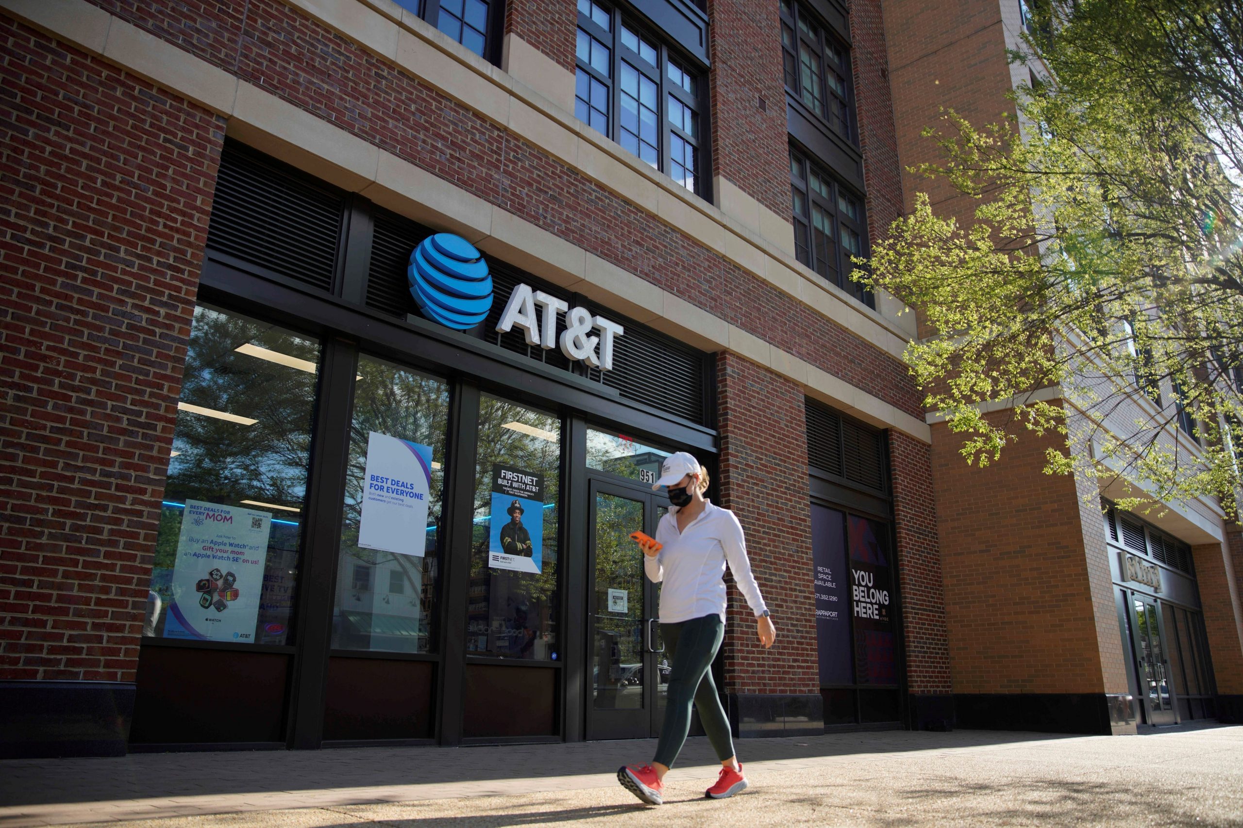 A woman walks by an AT&T store in Washington D.C., the United States.