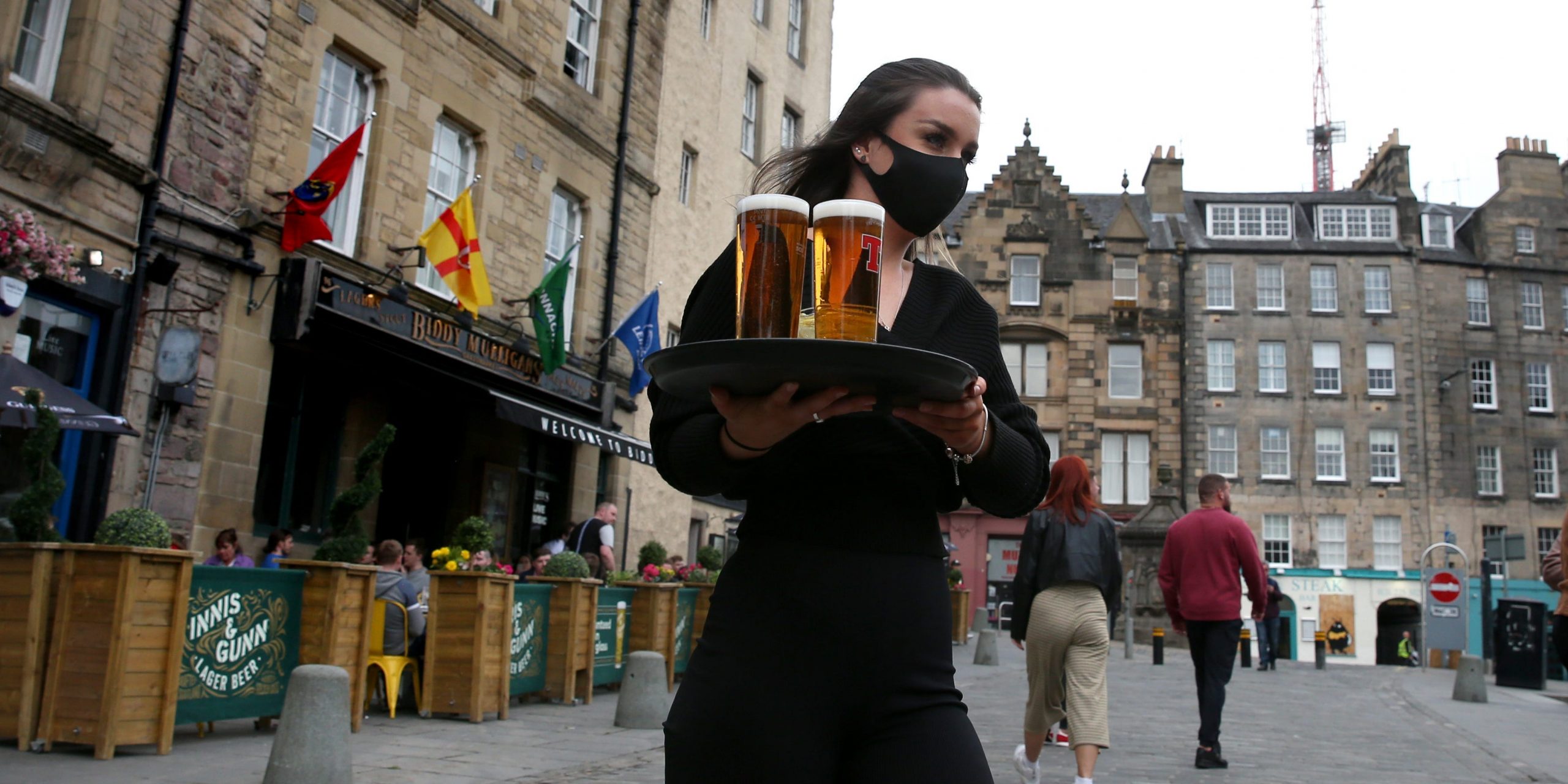 A server with a tray of beer.