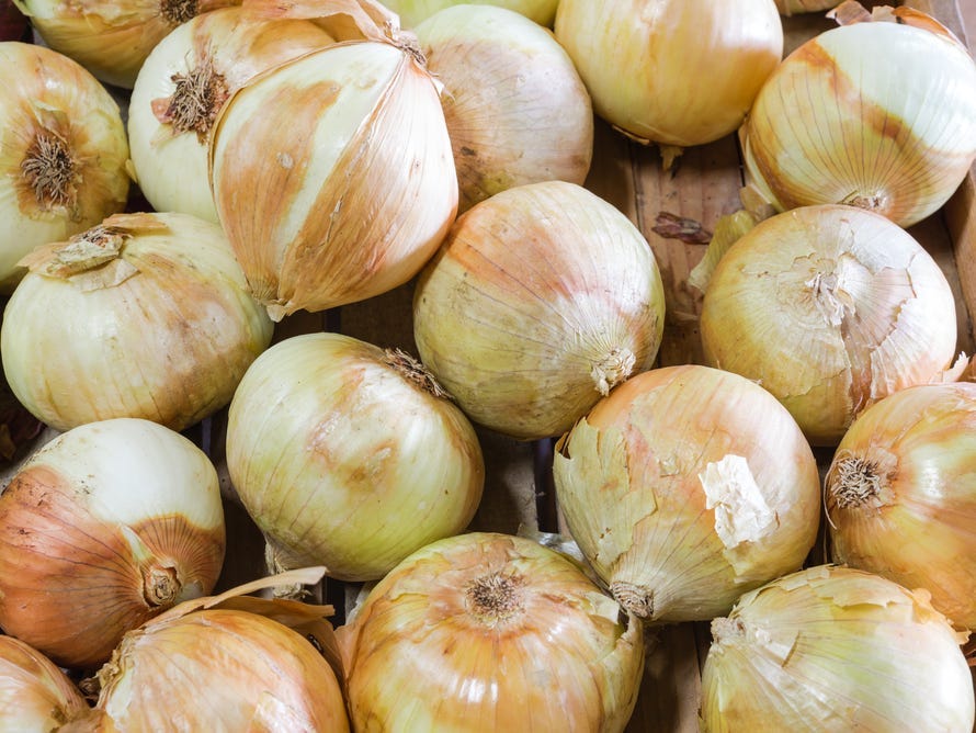 Close up shot of a basket of vidalia onions.