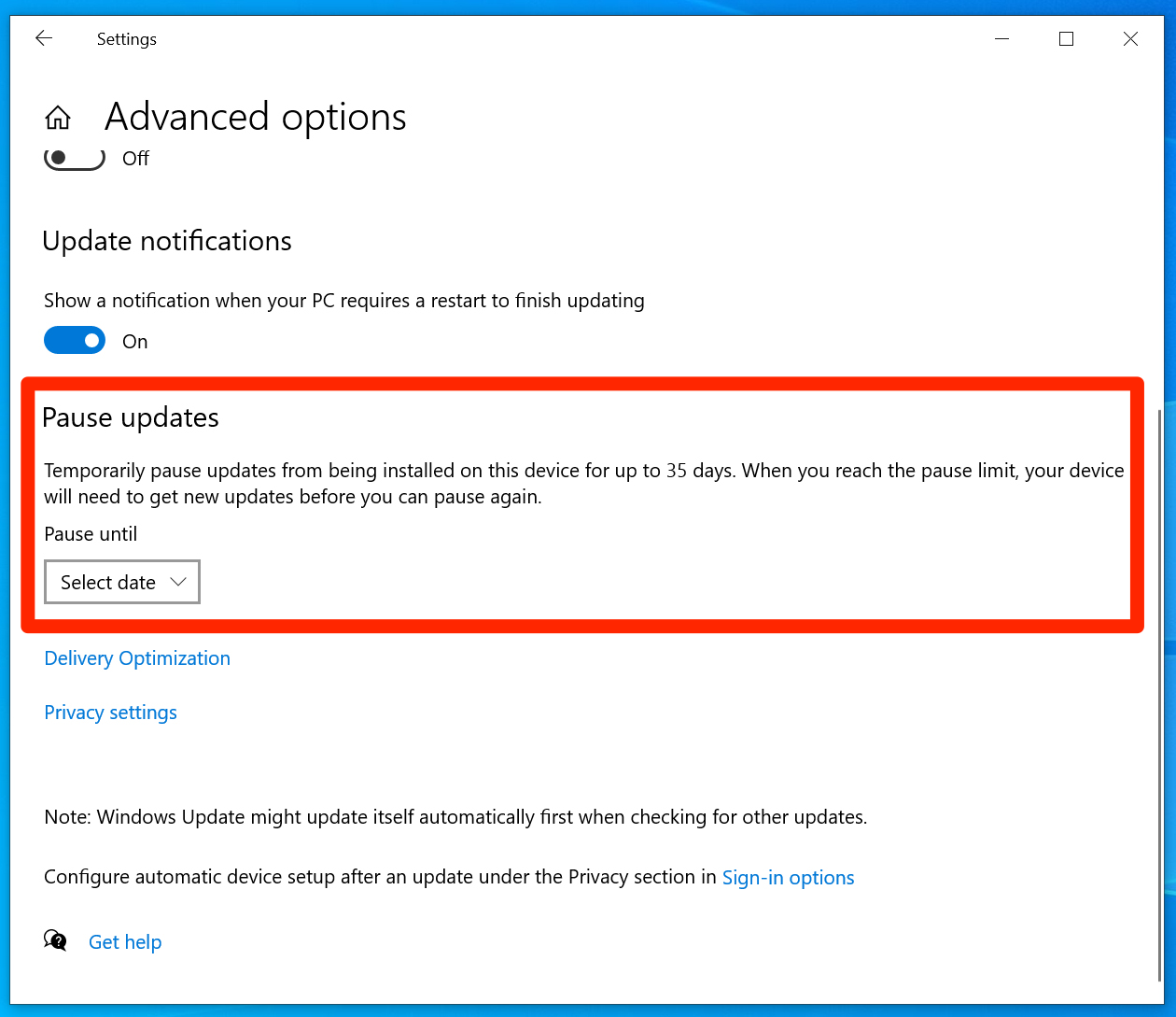 The Windows 10 update menu, with the option to pause updates highlighted.