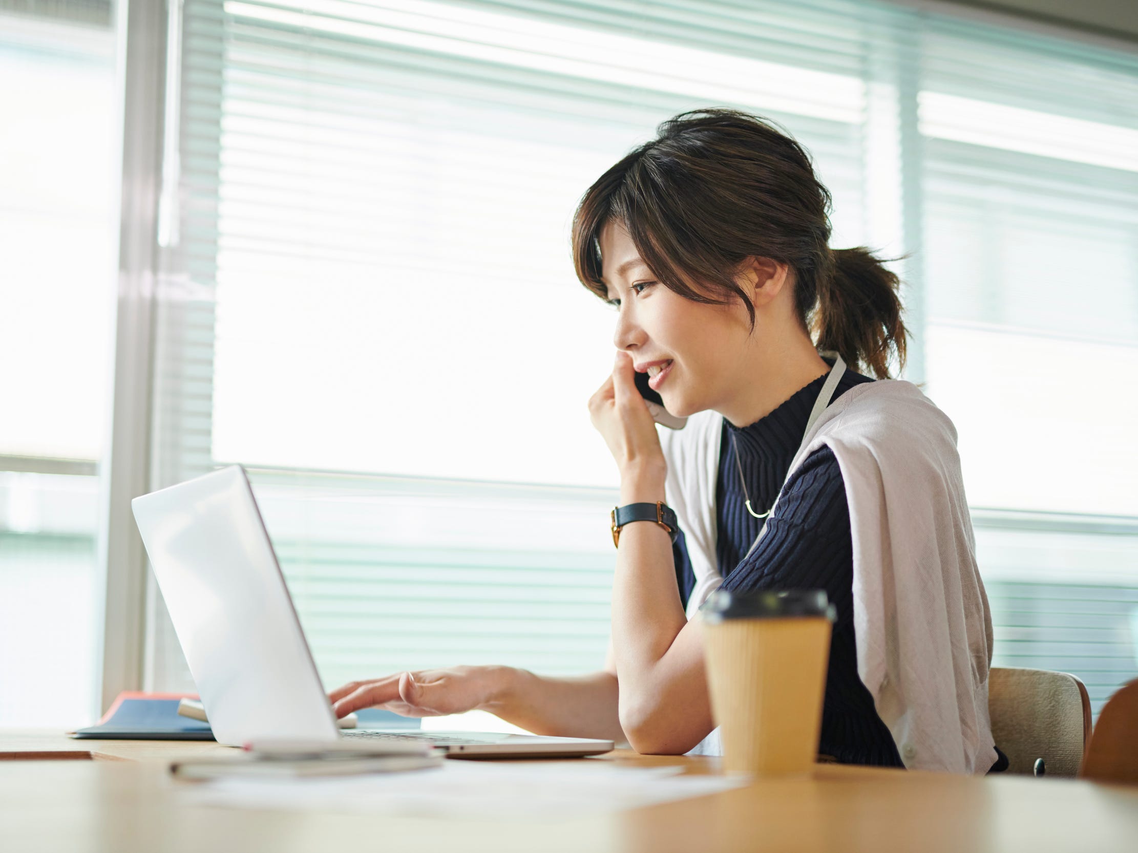 talking on phone with laptop