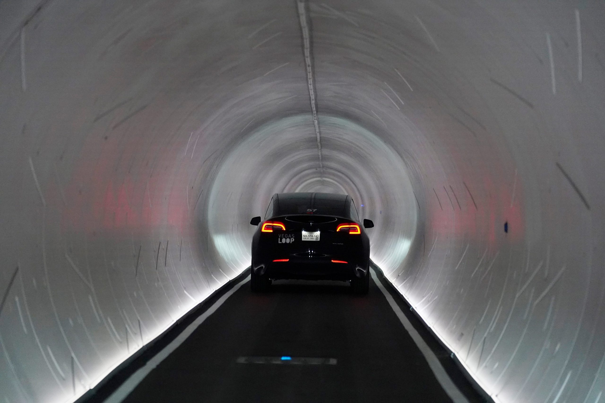 A Tesla vehicle drives into a round tunnel made by The Boring Company in Las Vegas