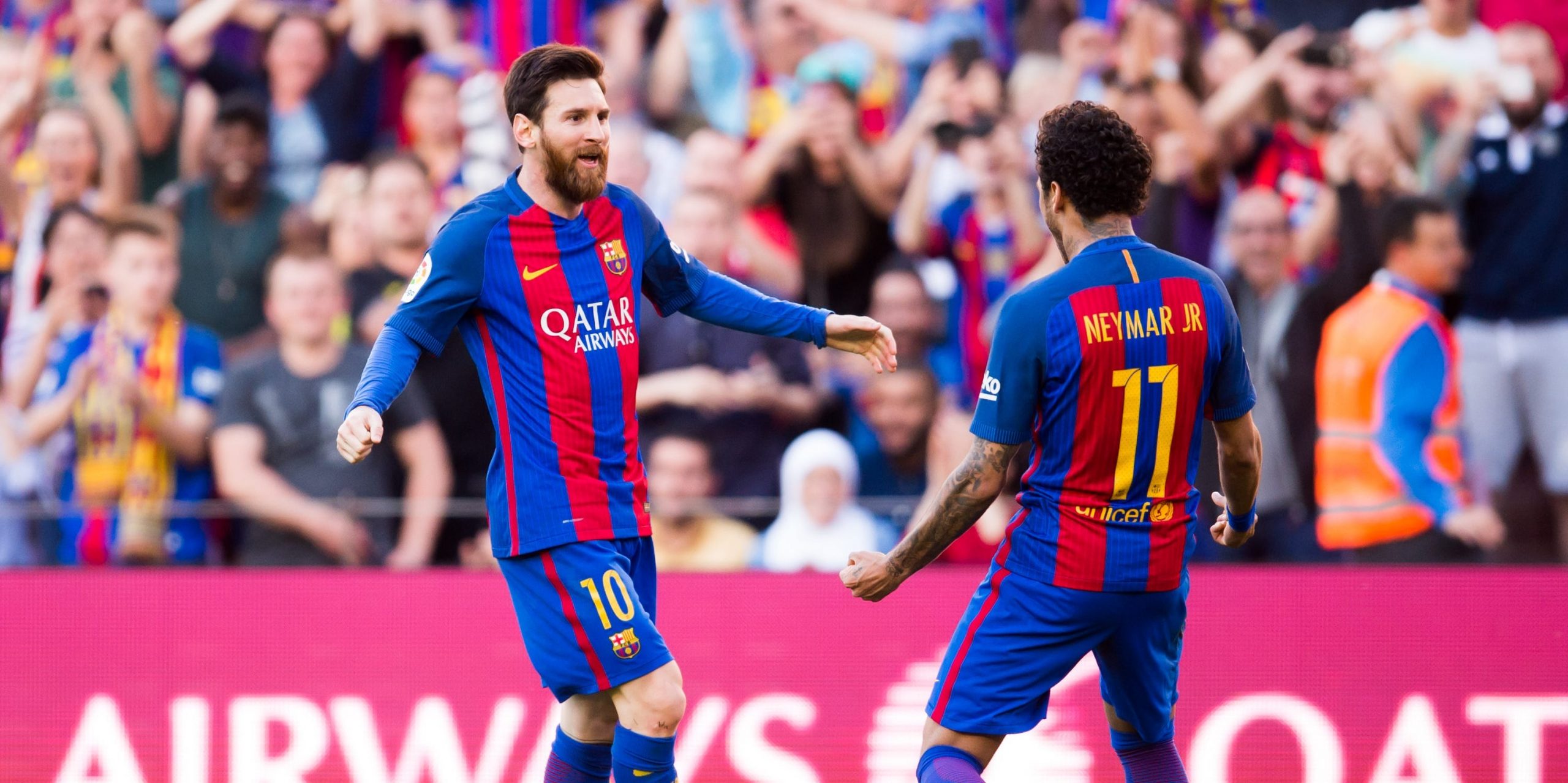 Barcelona players Lionel Messi celebrates with Neymar at the Camp Nou