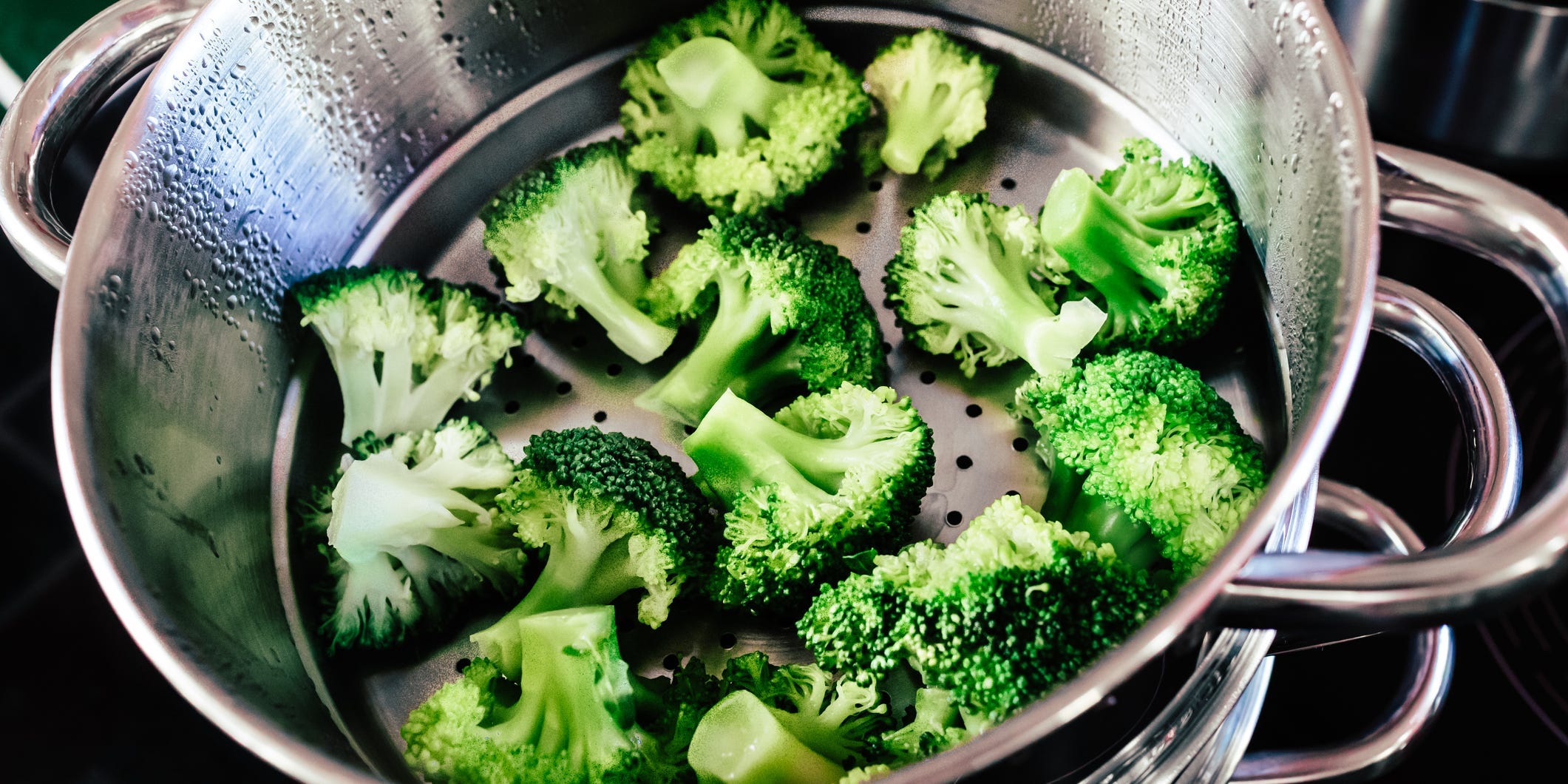 Broccoli in a steamer basket.
