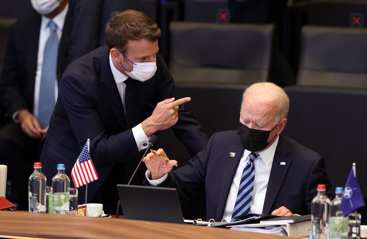 US President Joe Biden (R) and French President Emmanuel Macron (L) have a conversation ahead of the NATO summit at the North Atlantic Treaty Organization (NATO) headquarters in Brussels, on June 14, 2021.