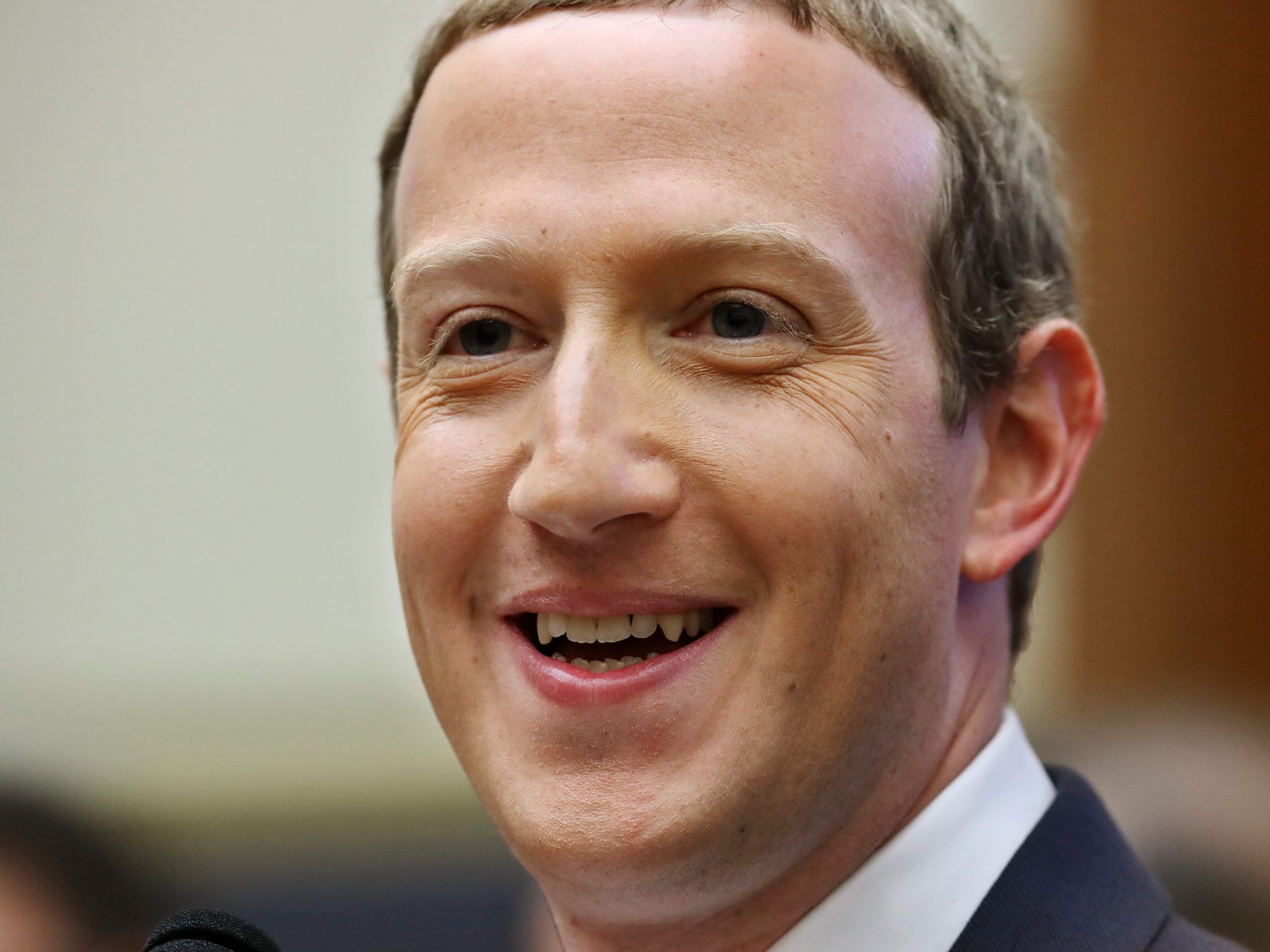 Photo of Facebook CEO Mark Zuckerberg smiling during his testimony to The House Financial Services Committee on October 23, 2019