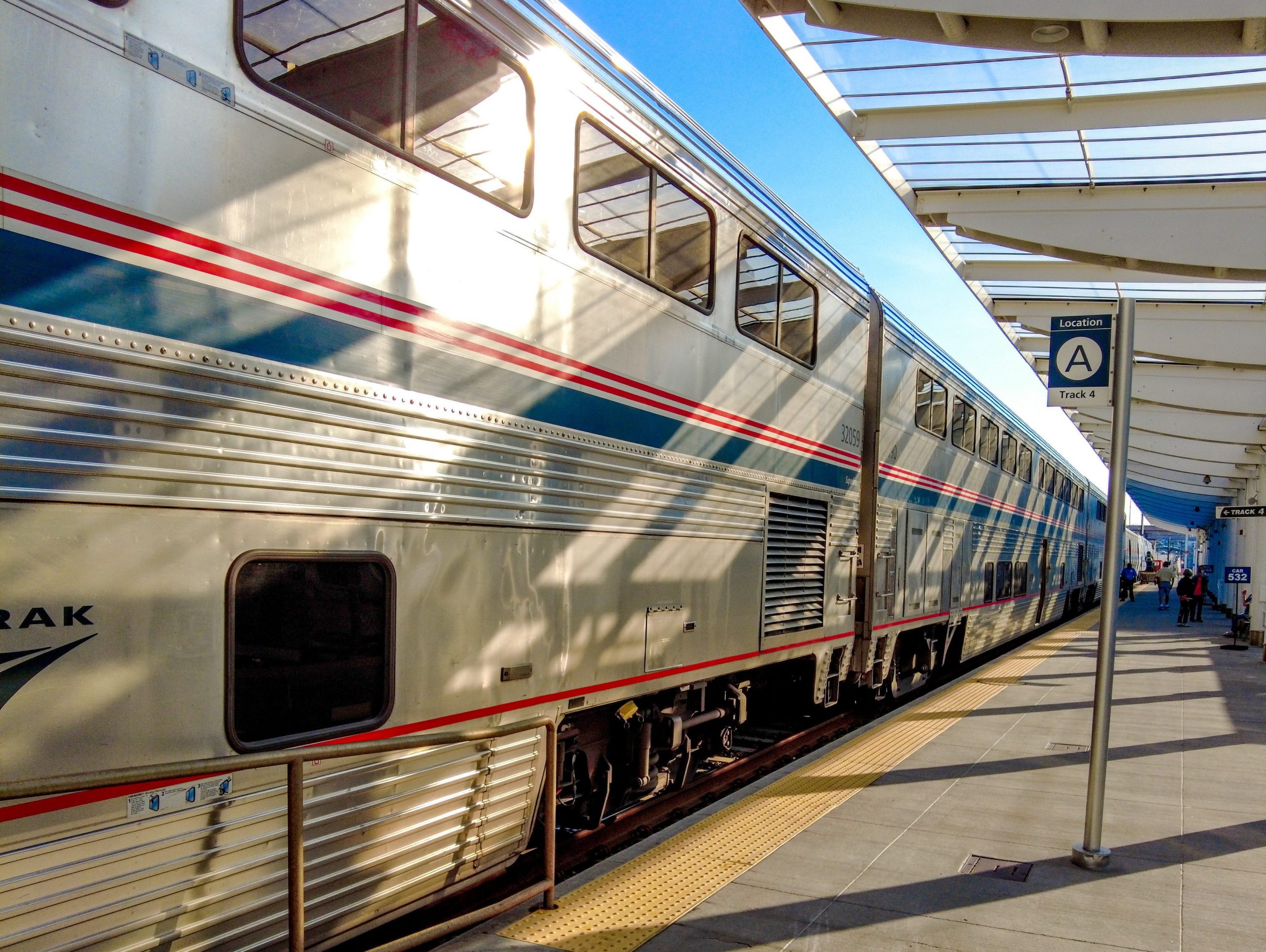 The silver, blue, and red Amtrak train at the concrete platform