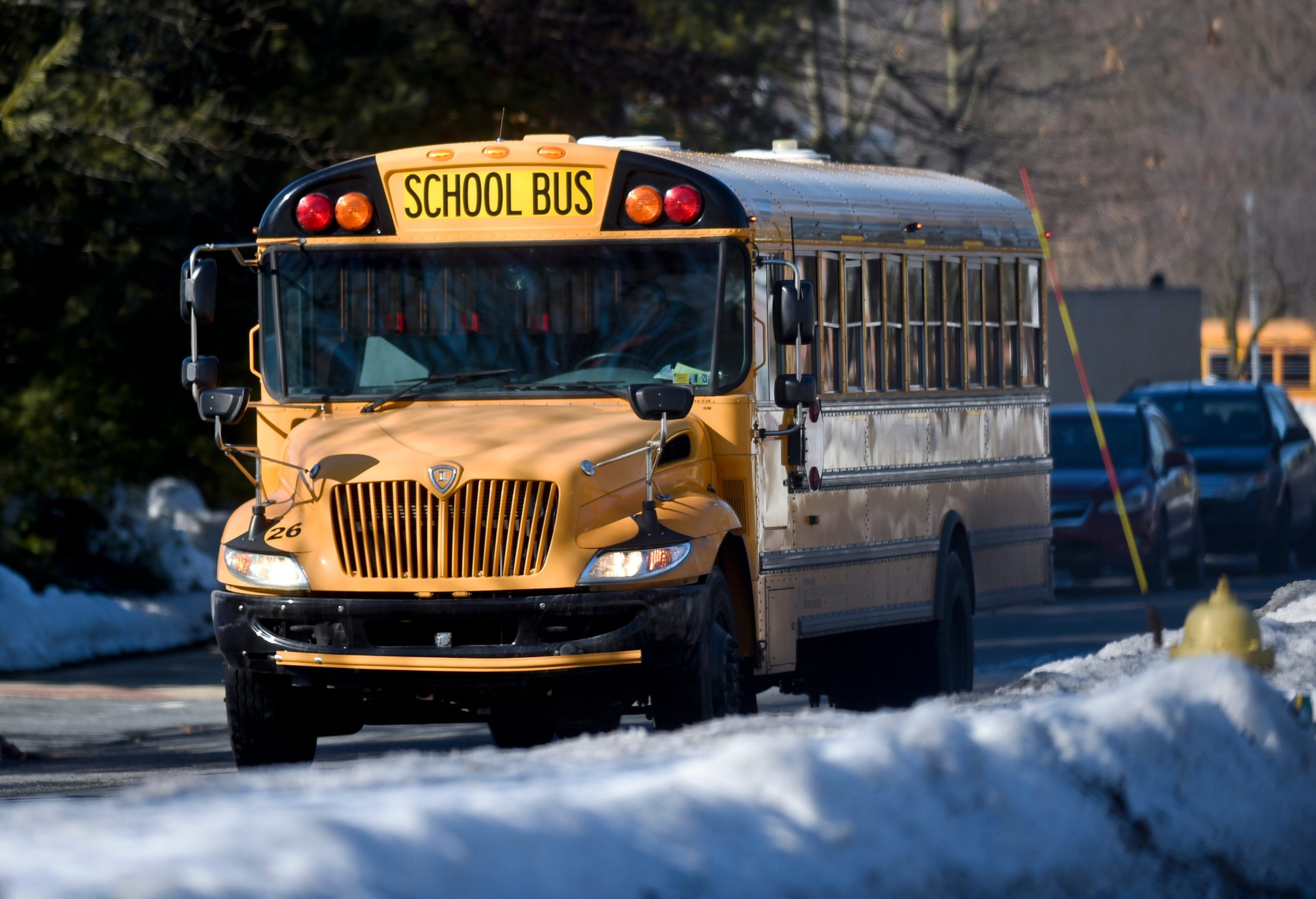 A school bus travels South with snow drifts in the middle of the road on Mifflin Blvd. in Cumru township