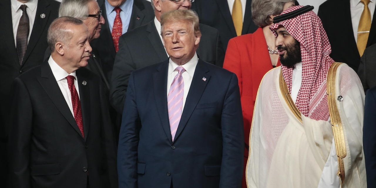 Turkish President Recep Tayyip Erdogan (L), US President Donald Trump (C) and Crown Prince of Saudi Arabia Mohammad Bin Salman (R) pose for the family photo on the first day of the G20 summit in Osaka, Japan on June 28, 2019.