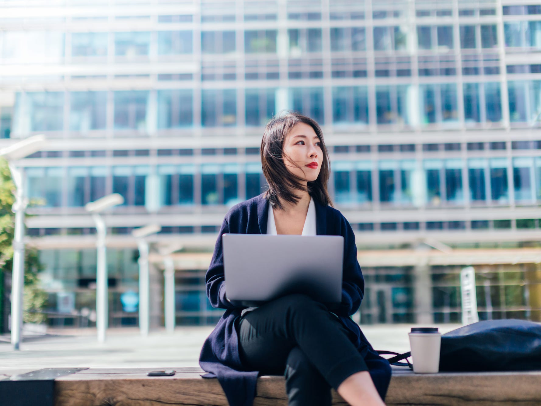 Businesswoman working with laptop outside