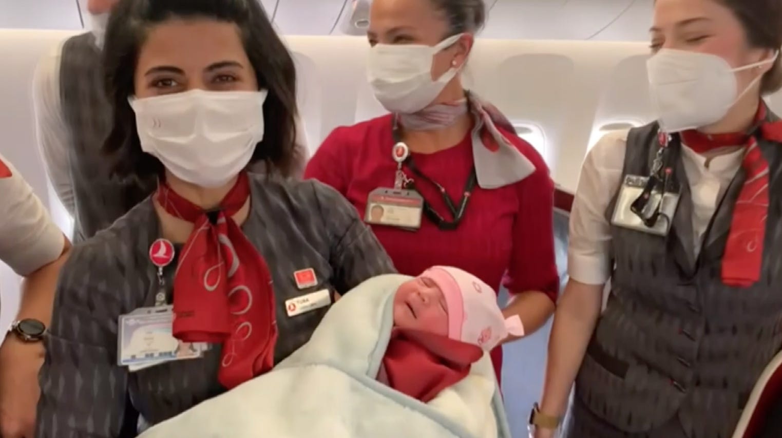 Turkish Airlines crew with newborn of flight passenger