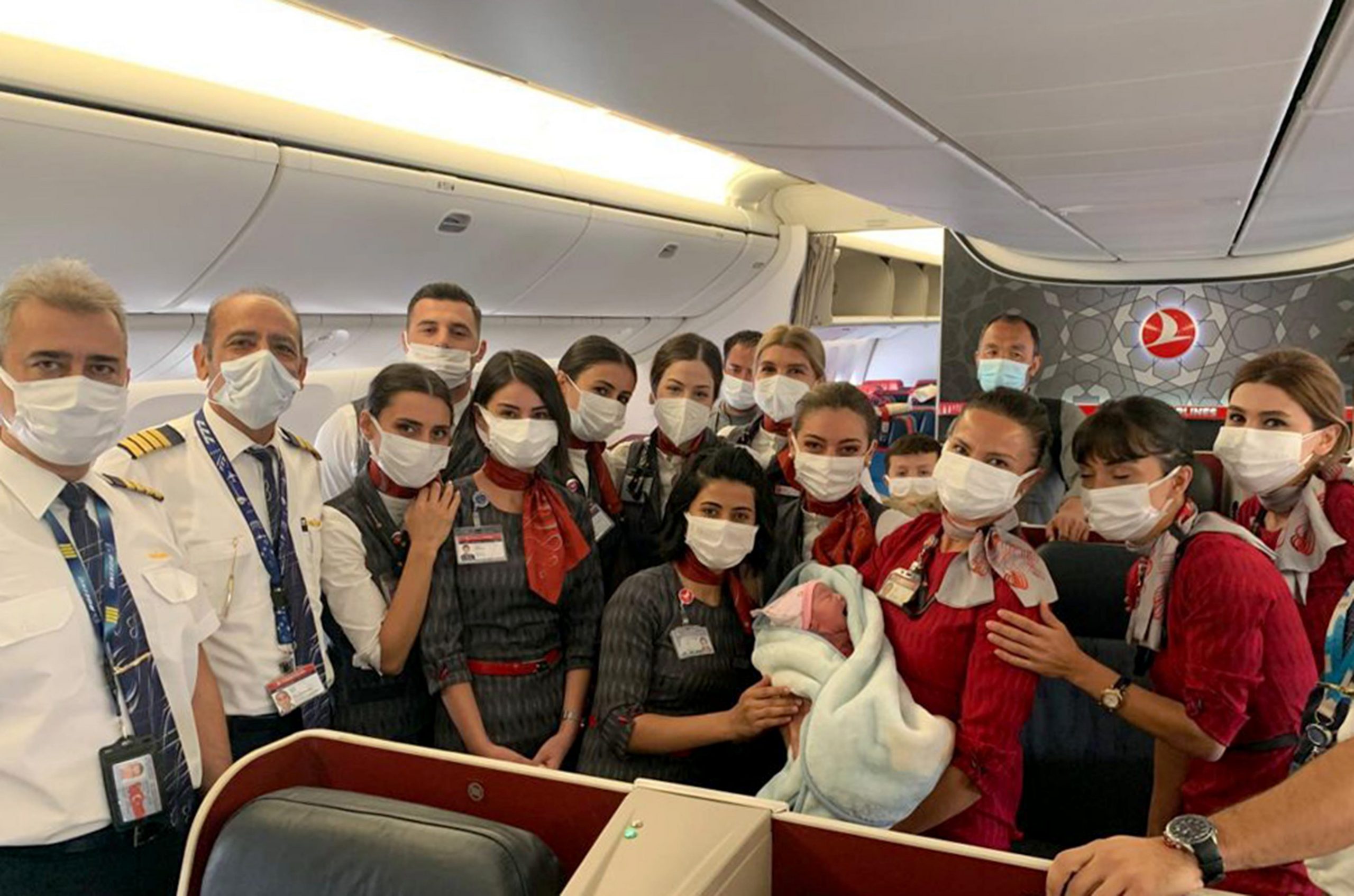 Turkish Airlines crew with newborn of flight passenger