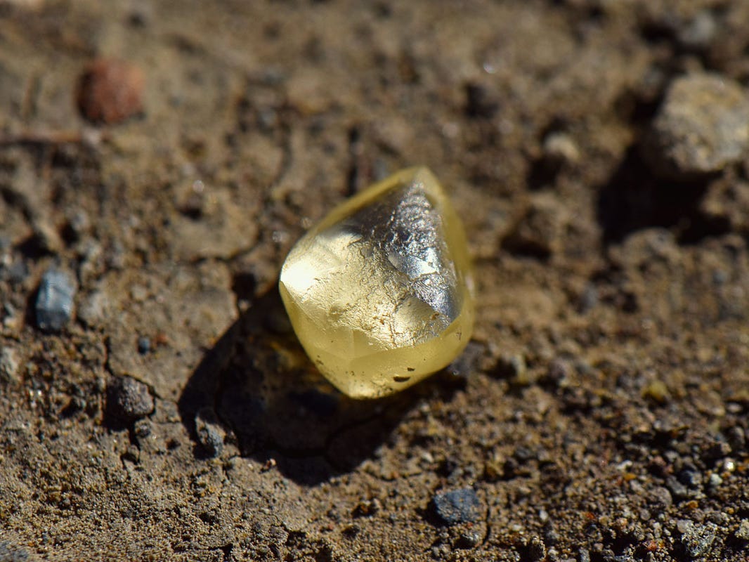 A 4.38-carat yellow diamond sitting on top of the ground