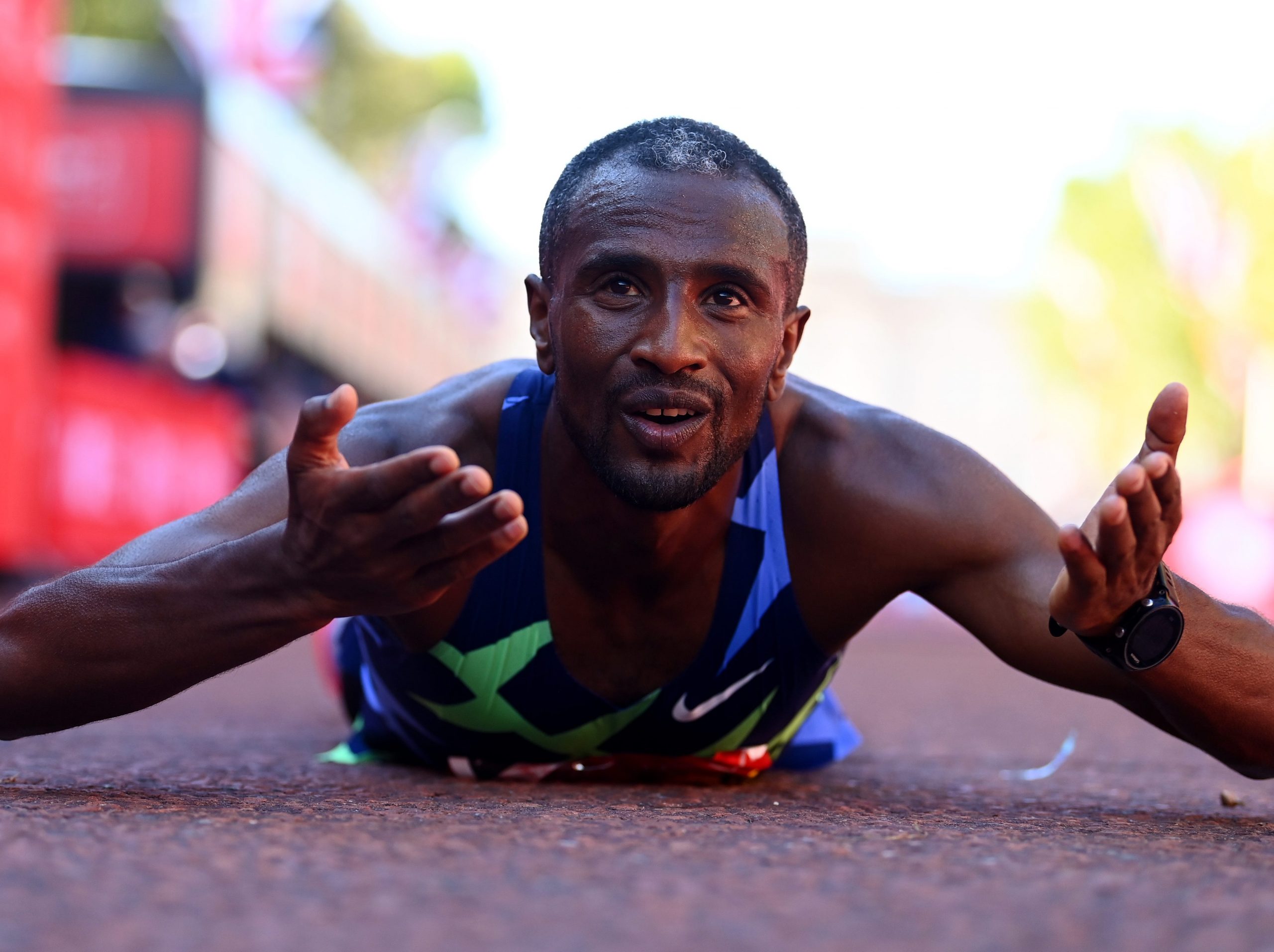 London Marathon winner Sisay Lemma lies on the floor after victory.