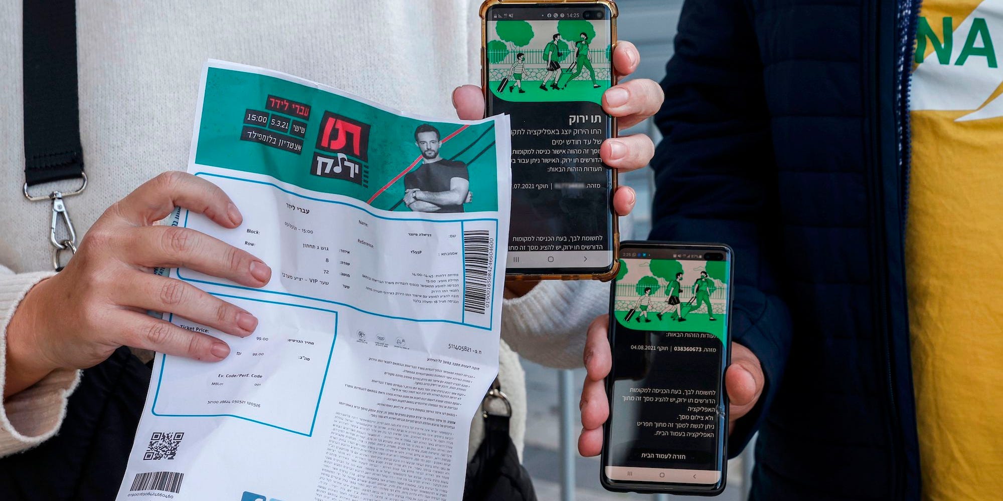 People's hands holding concert tickets and phaones displaying Israel's green pass.