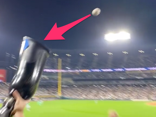 A White Sox fan catches a fly ball using her prosthetic leg.