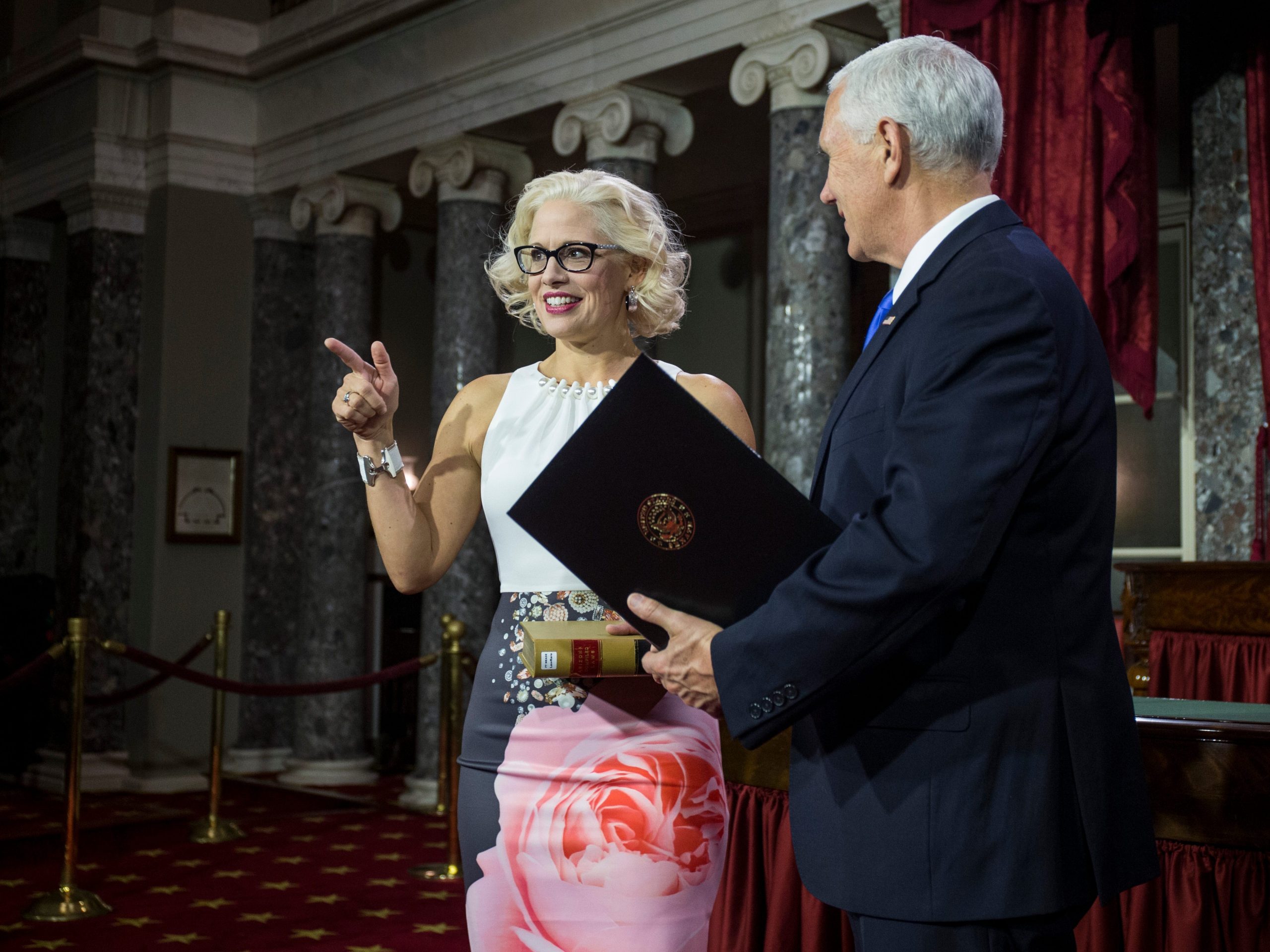 Democratic Sen. Kyrsten Sinema of Arizona participates in a mock swearing in ceremony with Vice President Mike Pence on Capitol Hill on January 3, 2019.