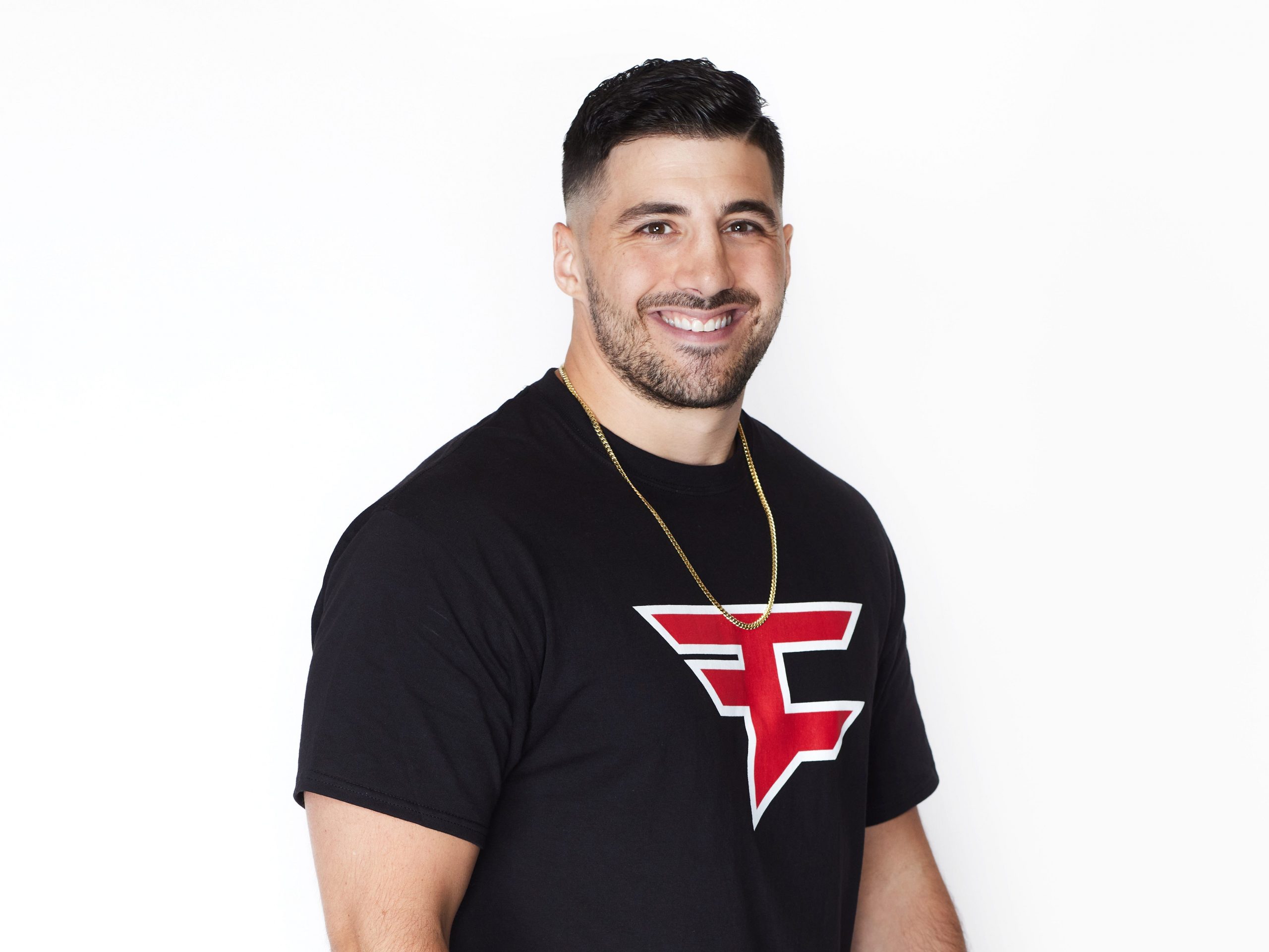 Nickmercs standing in a black Faze shirt in front of a white background