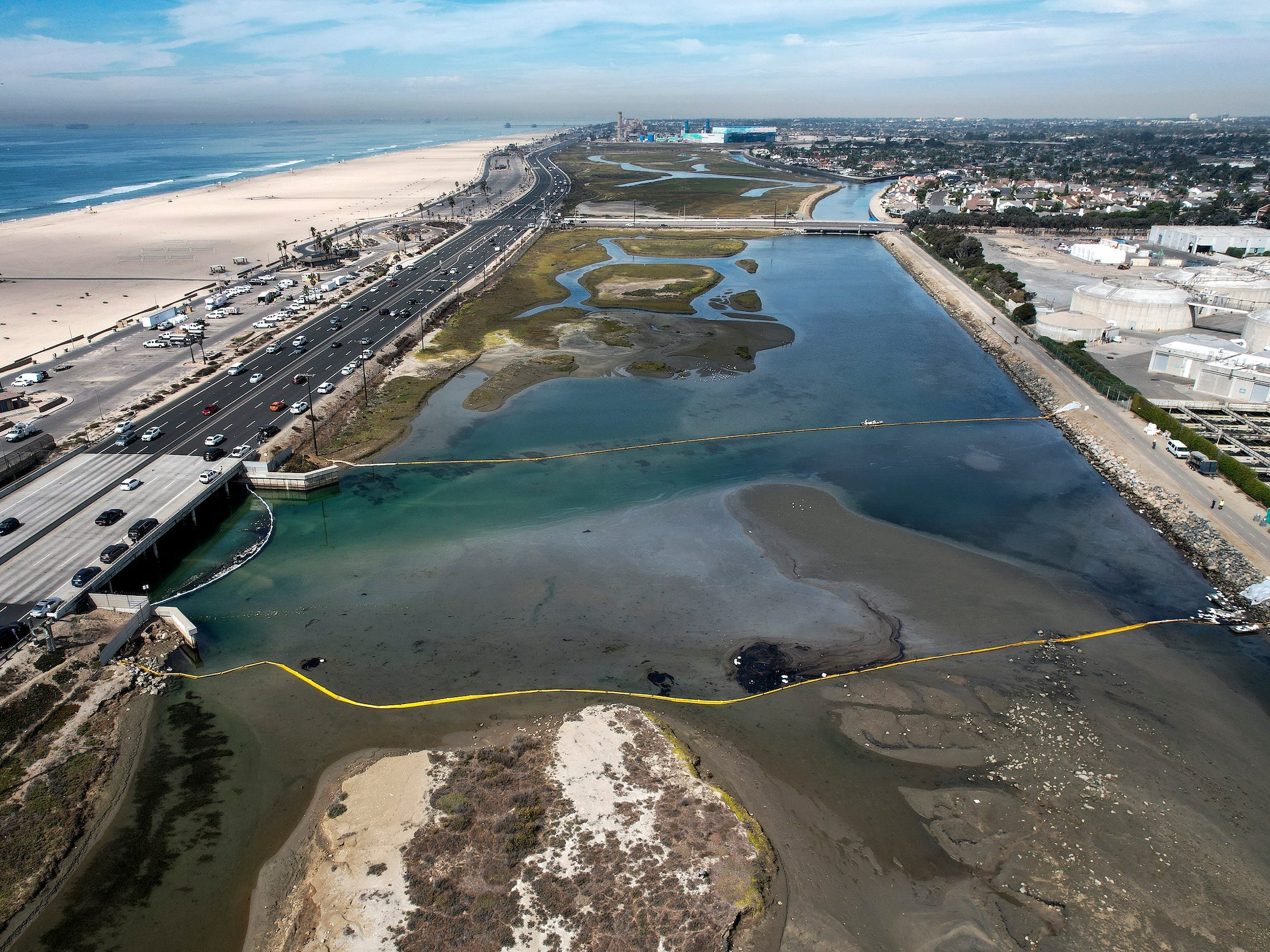 floating barriers hold back oil spill creeping into wetlands