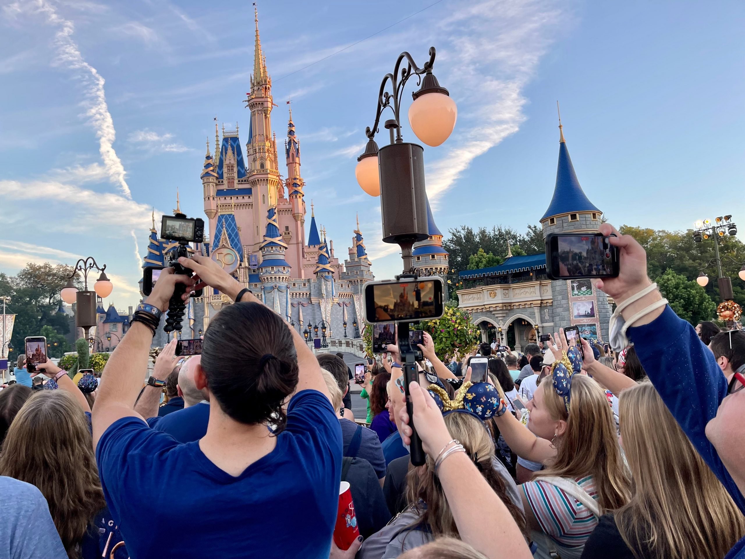 shot fo the crowds in front of cinderella castle on opening day of disney world 50th anniversary celebration