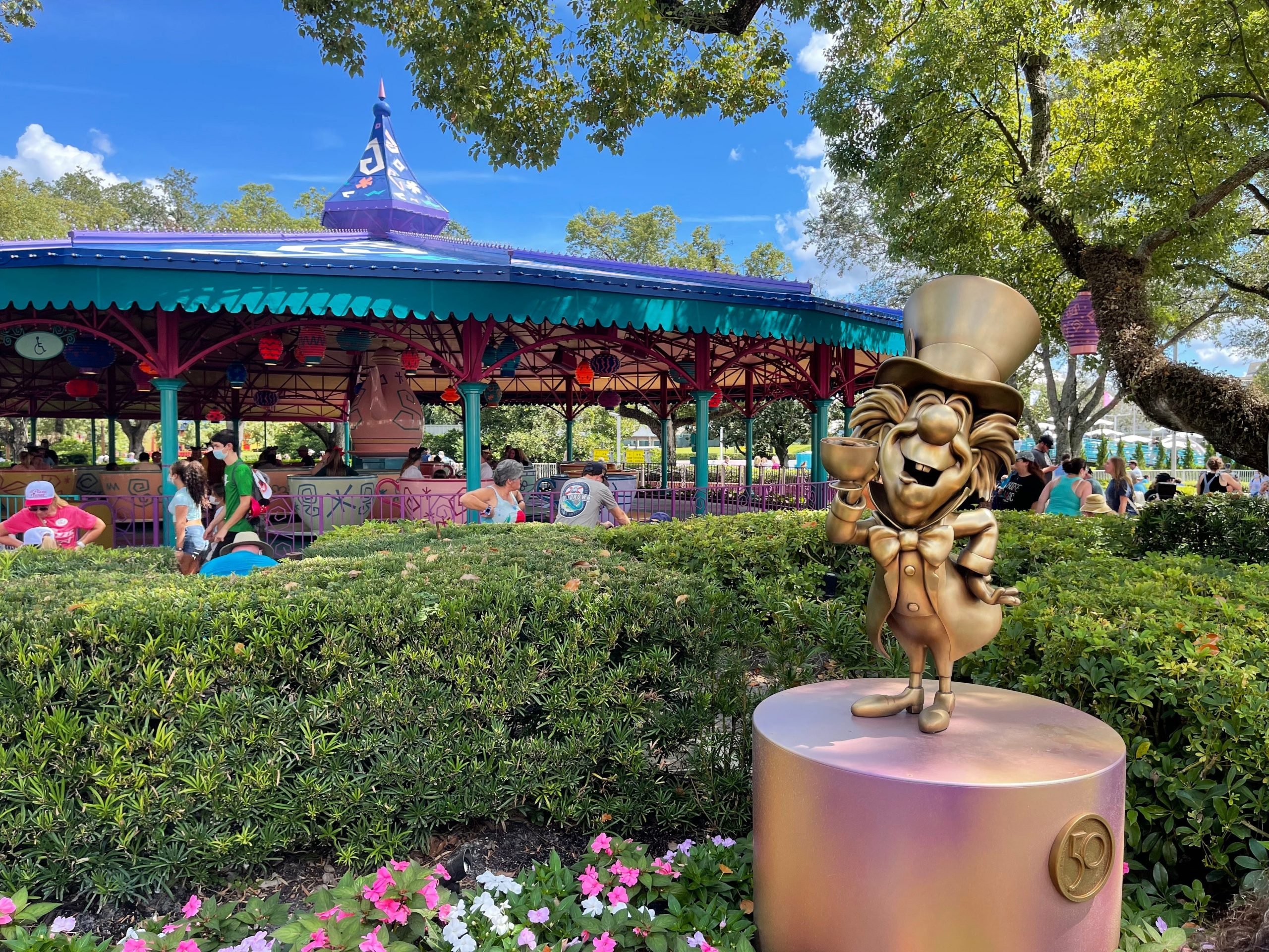 new mad hatter statue in front of teacup ride disney world 50th anniversary