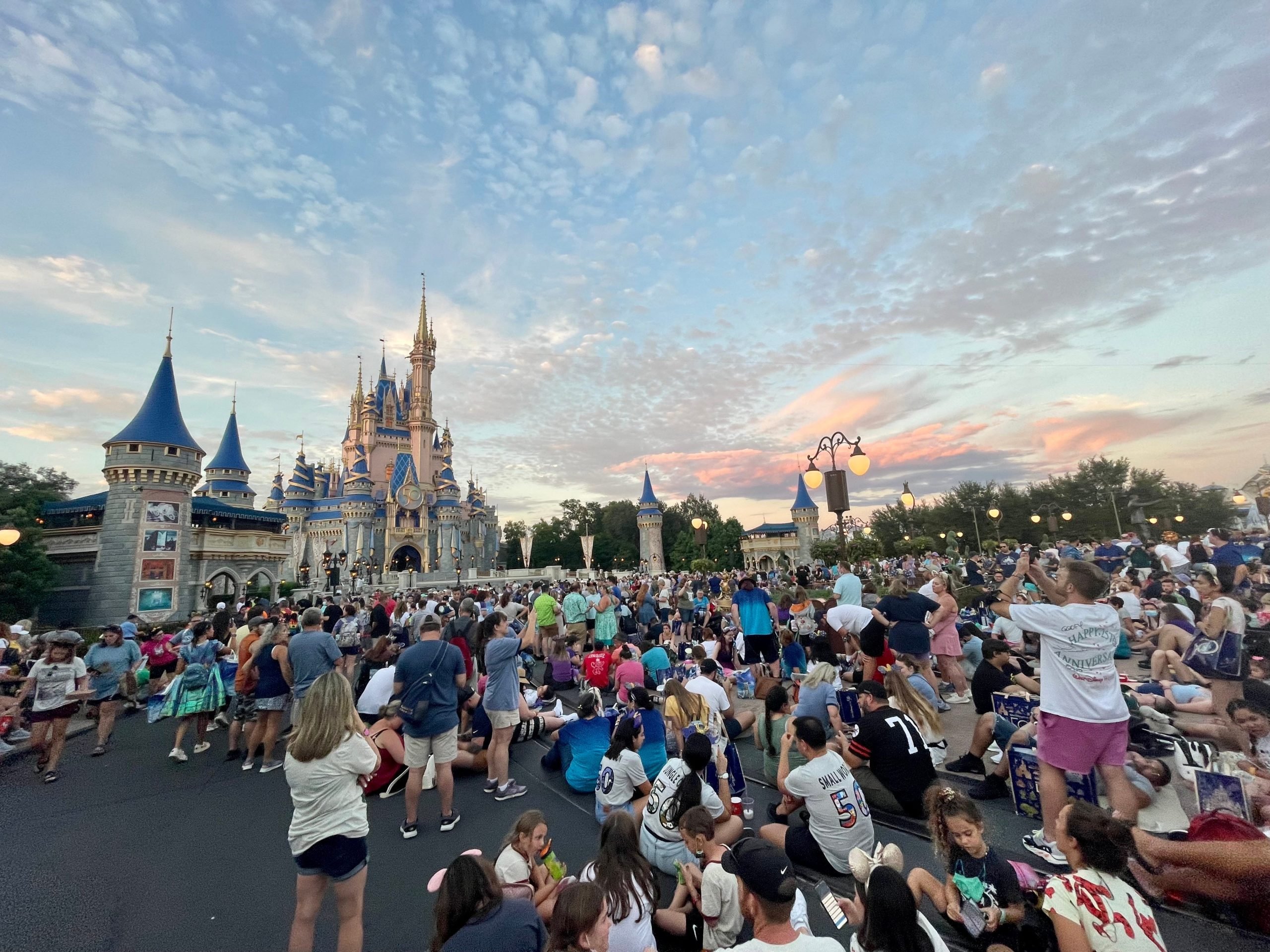 people crowding to watch the magic kingdom fireworks 50th anniversary celebration