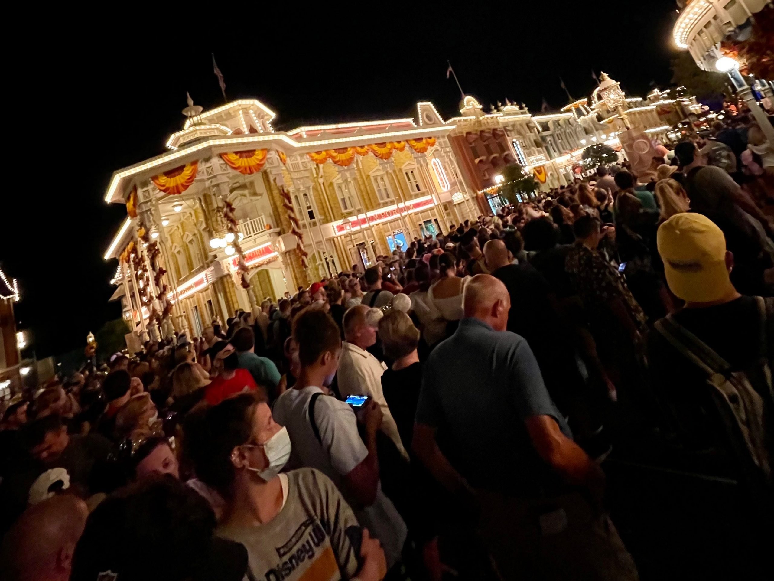 main street usa magic kingdom crowded with people during the new fireworks show 50th anniversary