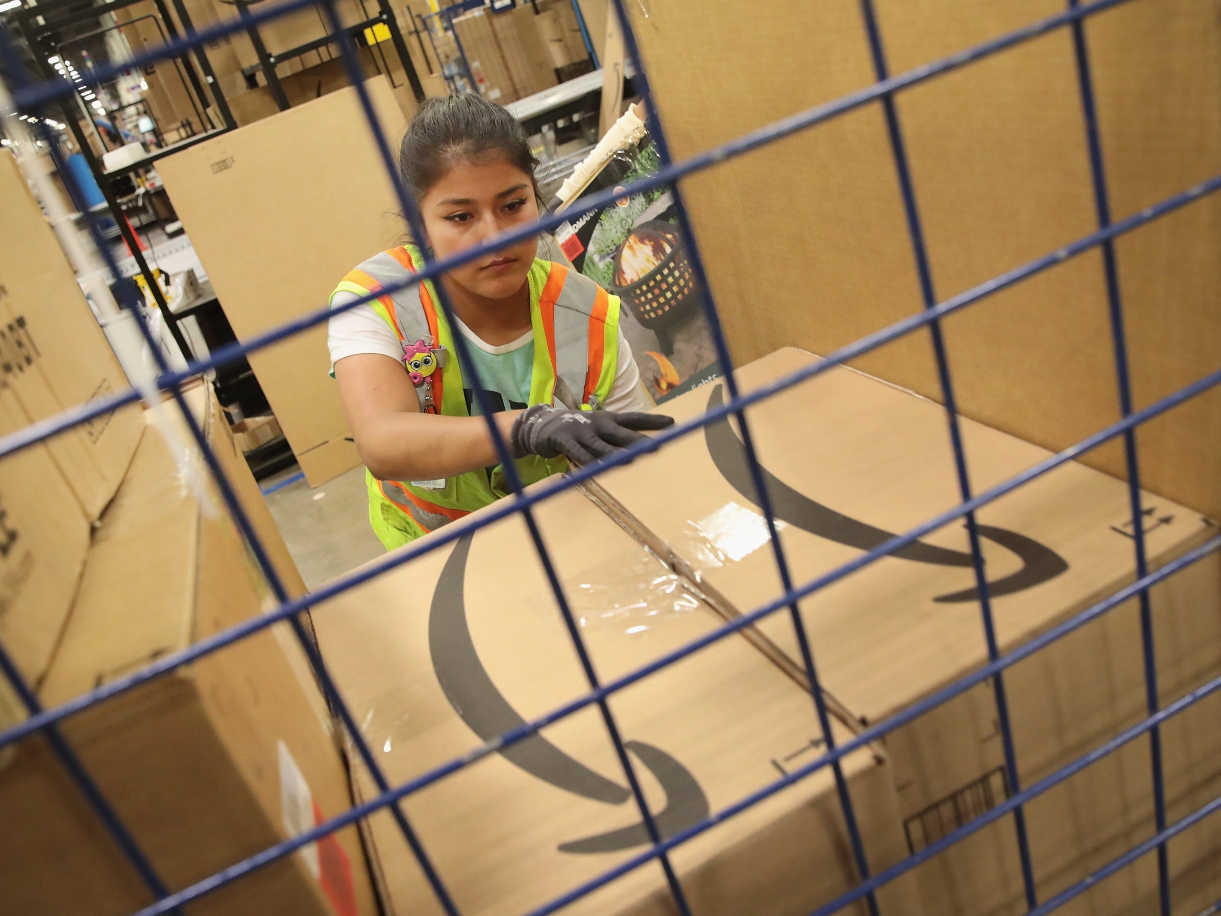 A worker packs a customer order at the 750,000-square-foot Amazon fulfillment center in Romeoville, Illinois.