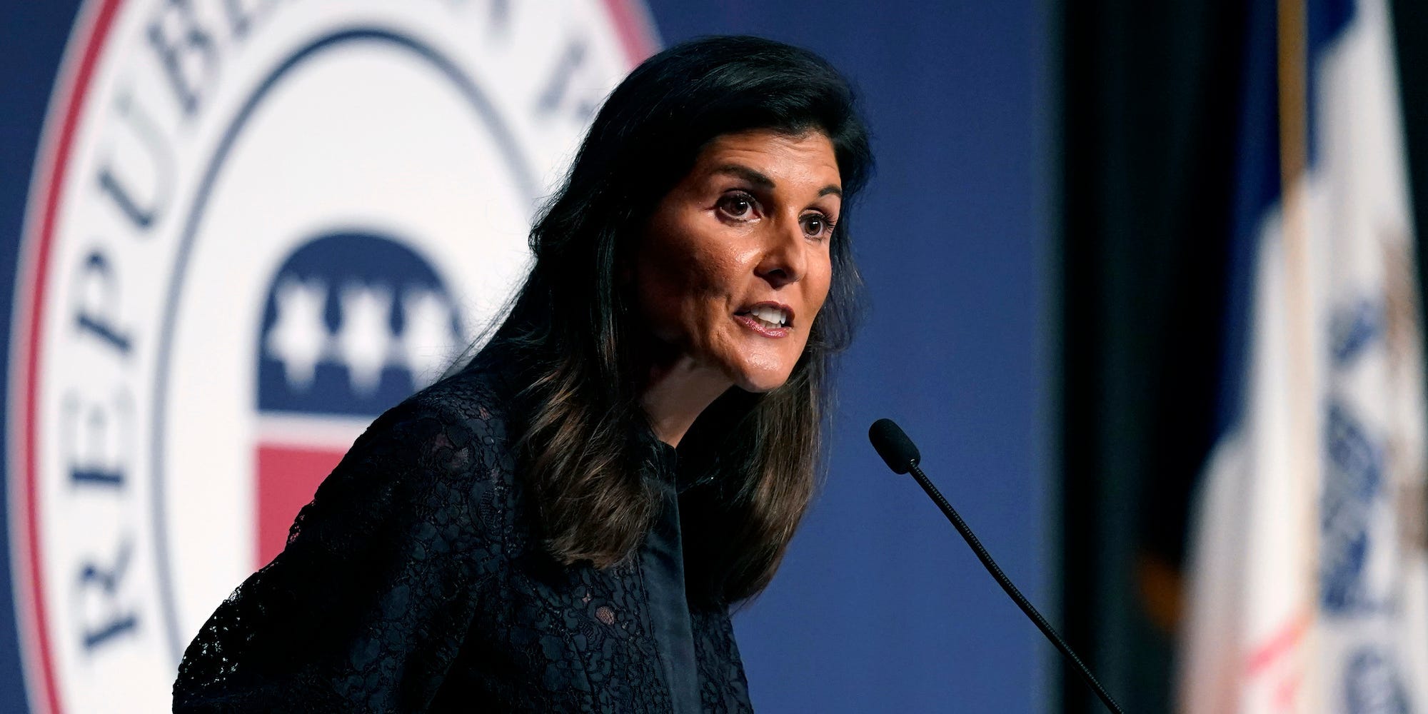 Nikki Haley standing in front of an Iowa Republican Party logo while speaking during the Iowa Republican Party's Lincoln Dinner,