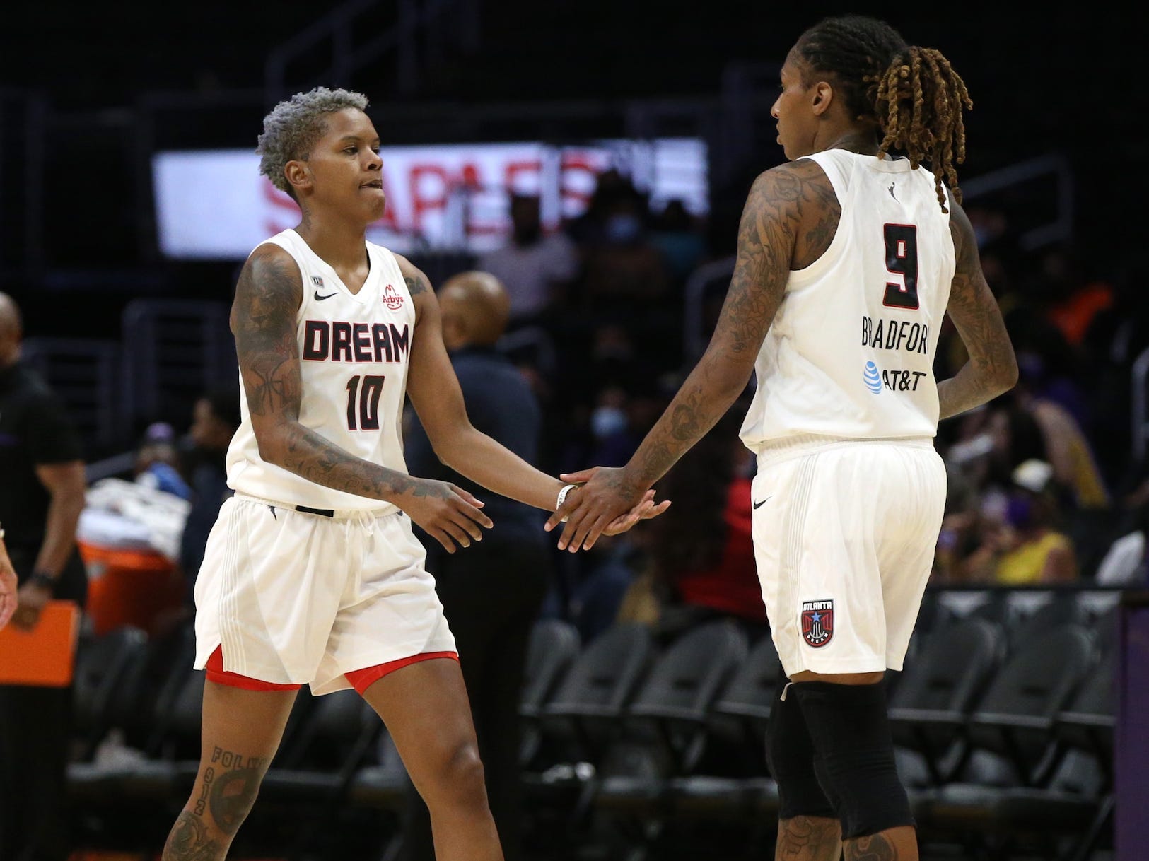 Courtney Williams high fives Crystal Bradford.