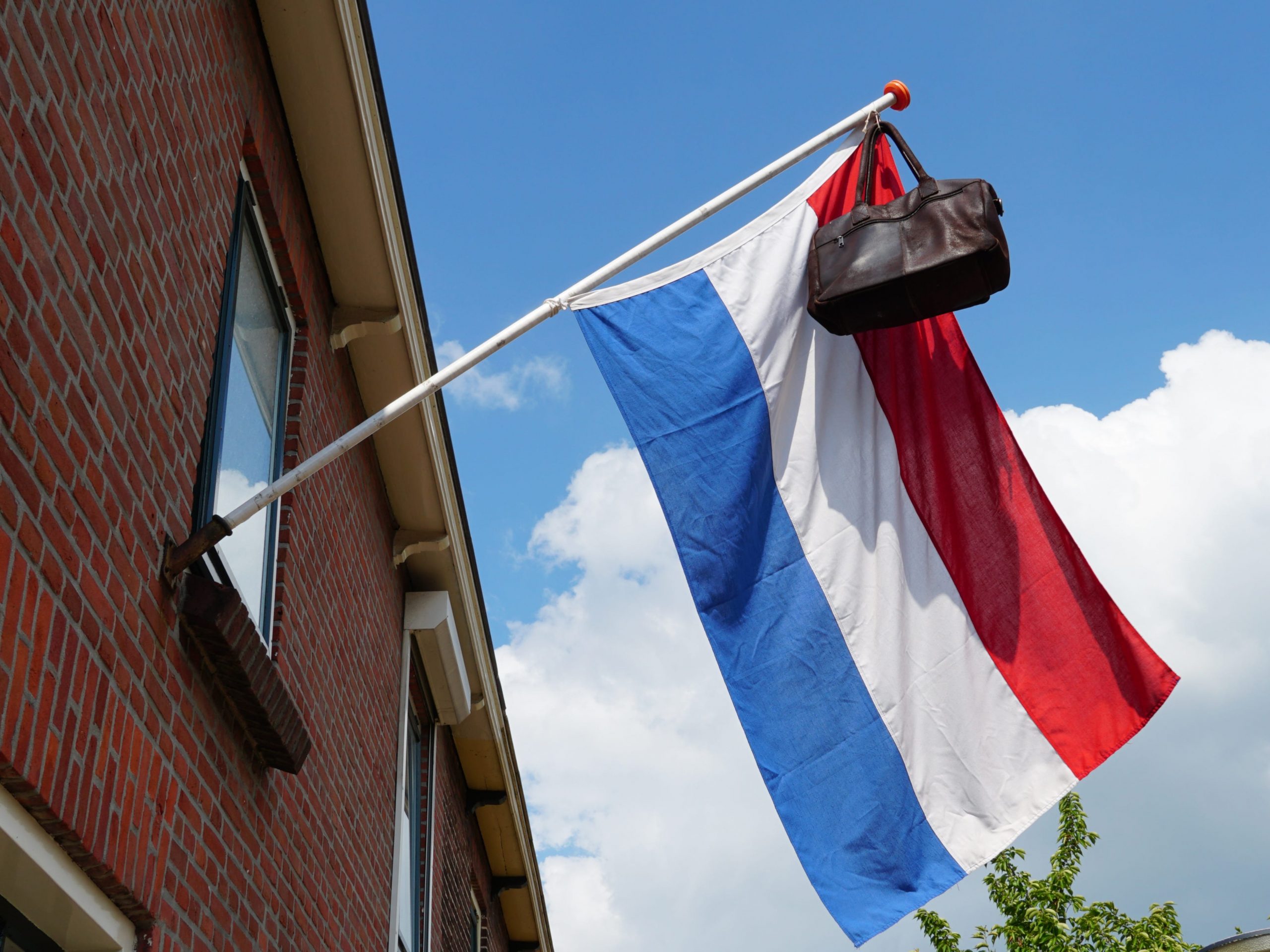 Official Dutch flag with a school bag, a tradition in the Netherlands when a student graduates.