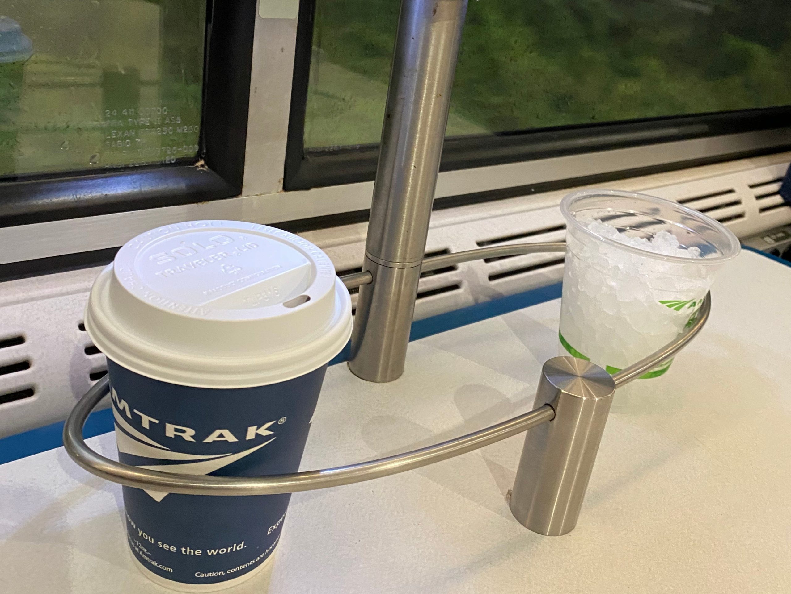 an Amtrak coffee cup and cup of ice