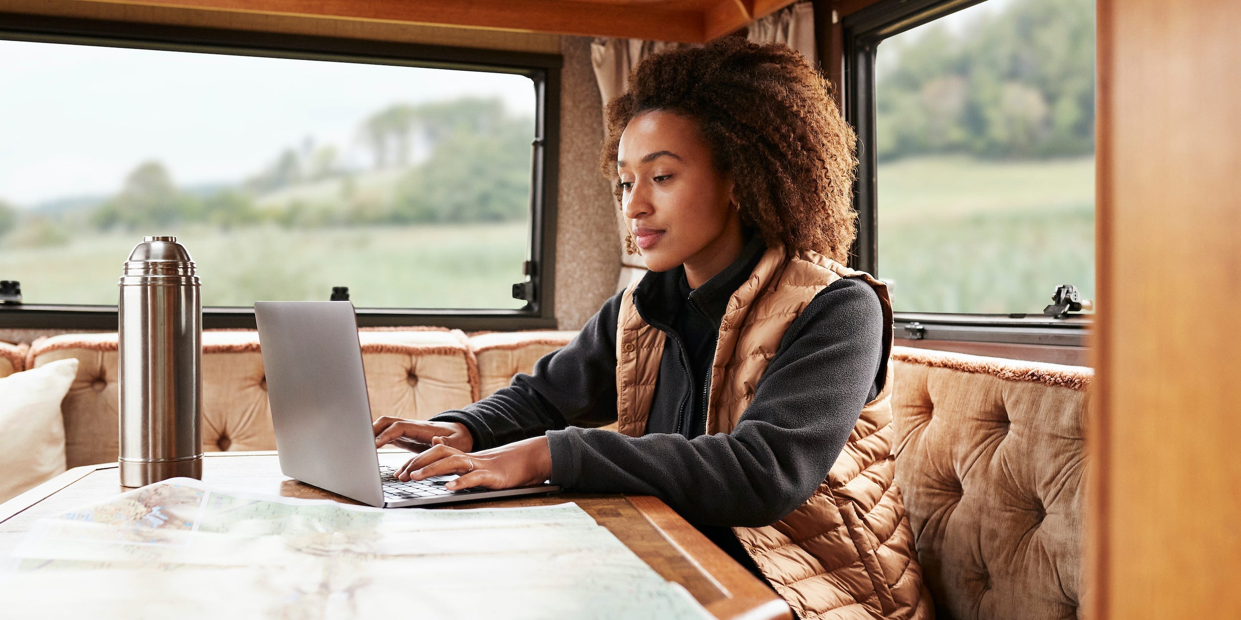 Young traveler using laptop in camper van