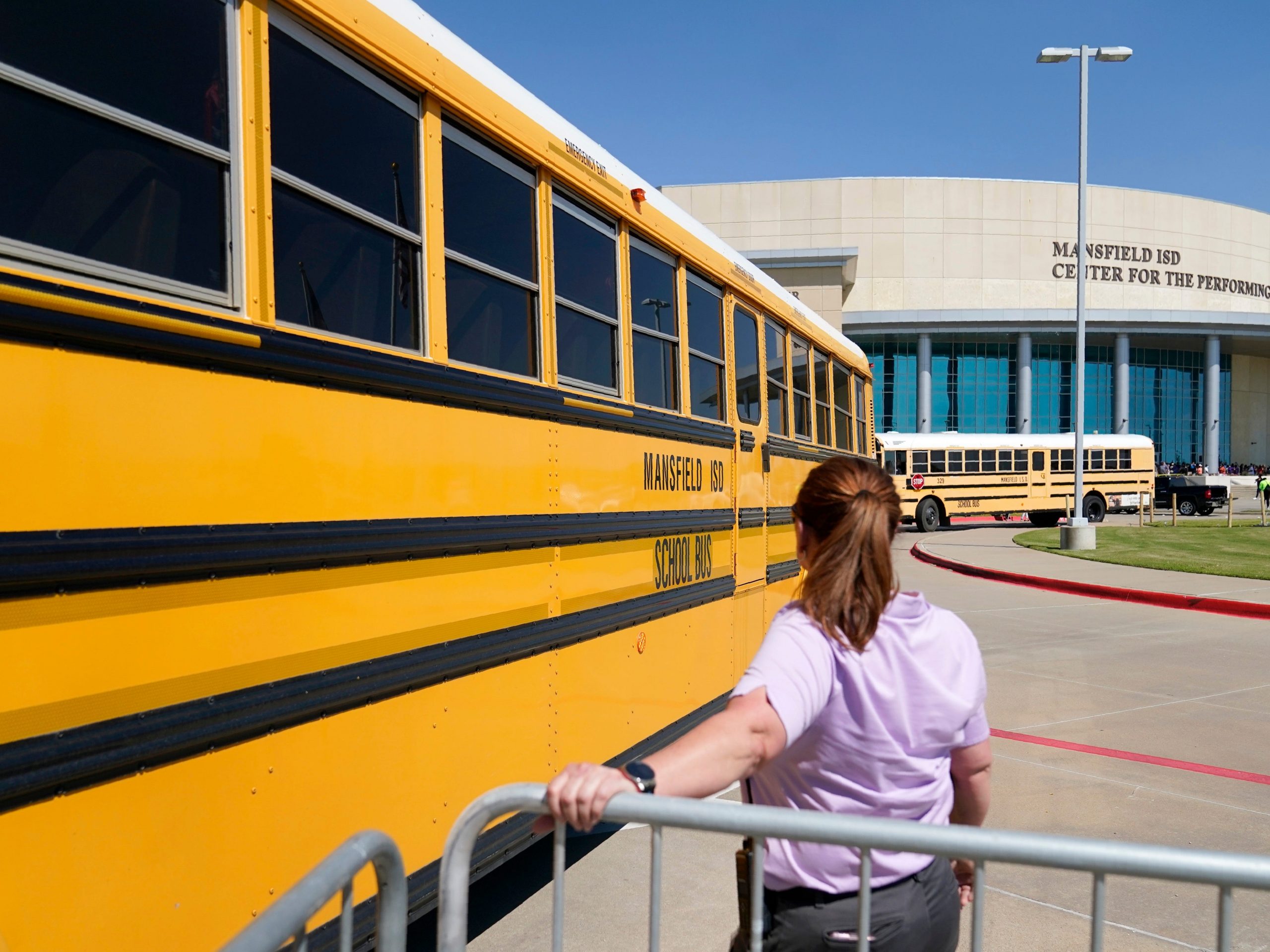 School busses depart following a school shooting in Arlington, Texas.