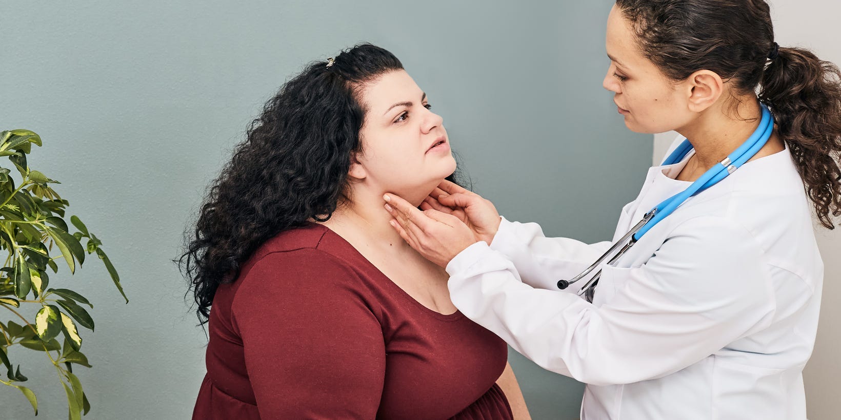 doctor checking a woman's thyroid gland