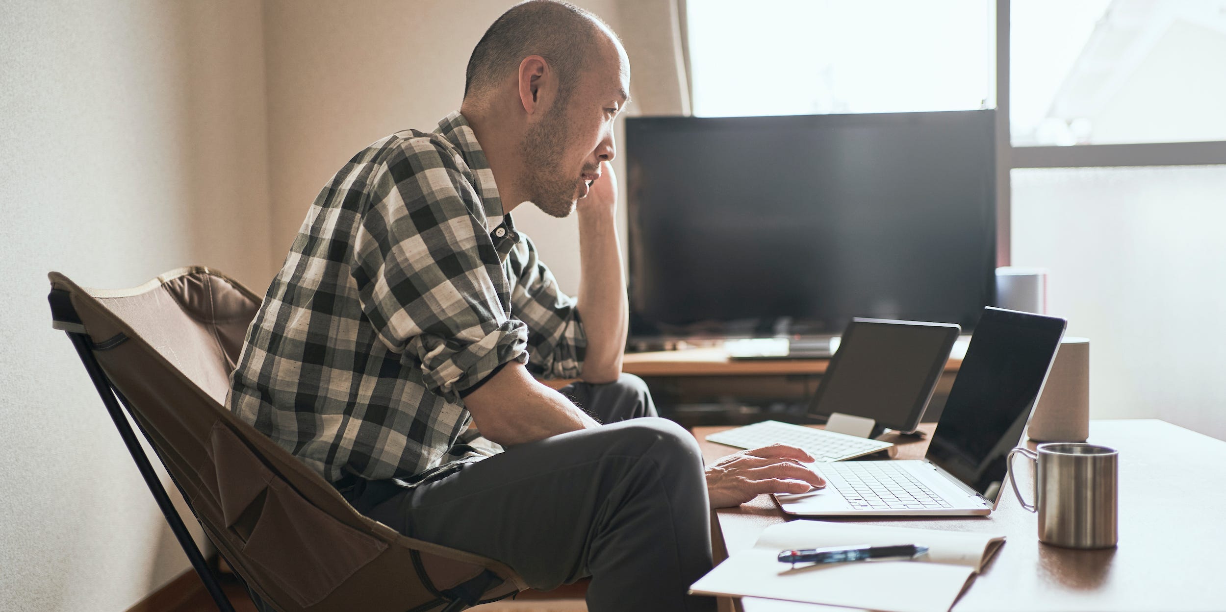 man using laptop computer and tablet working