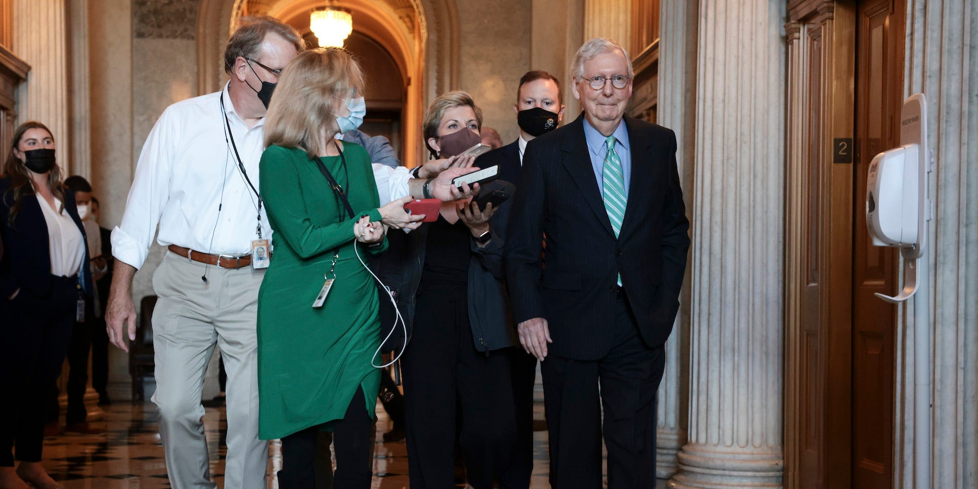 Republican Senate Minority Leader Mitch McConnell is followed by reporters as he arrives to a luncheon with Senate Republicans amid debt ceiling negotiations on October 07, 2021.