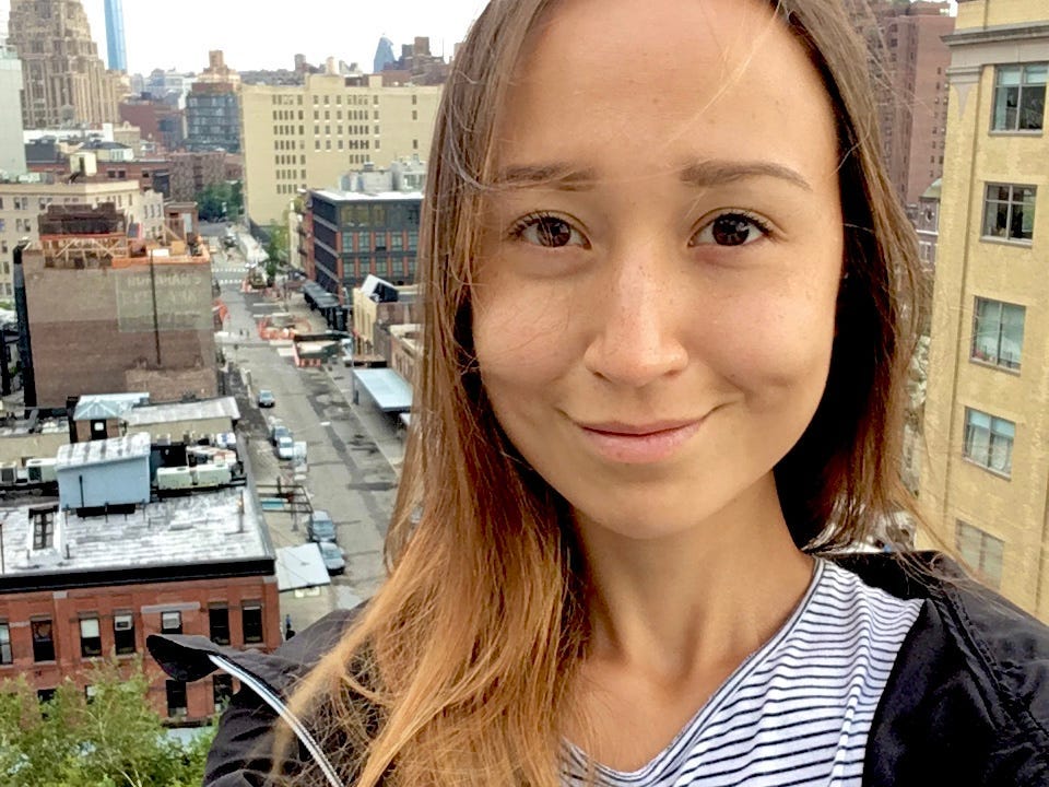 The writer taking a selfie off her New York balcony overlooking the busy street