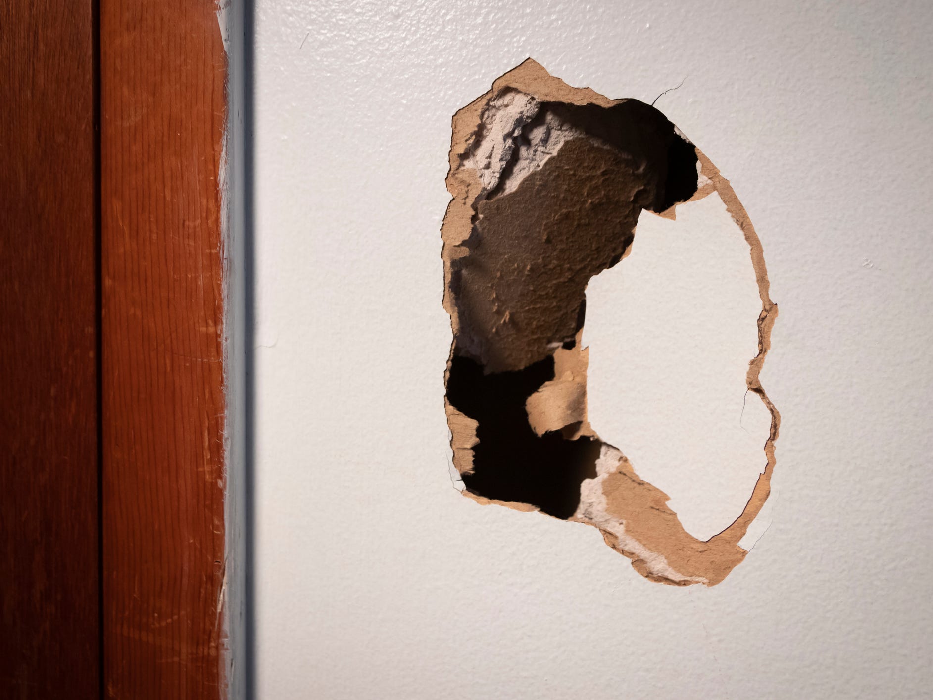 A large hole in a drywall wall